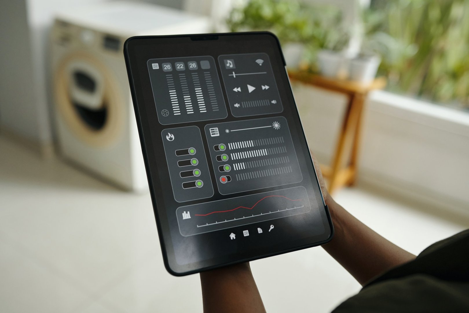 User interacting with tablet showing home automation control panel with various settings and options in high-tech environment with bright indoor surroundings