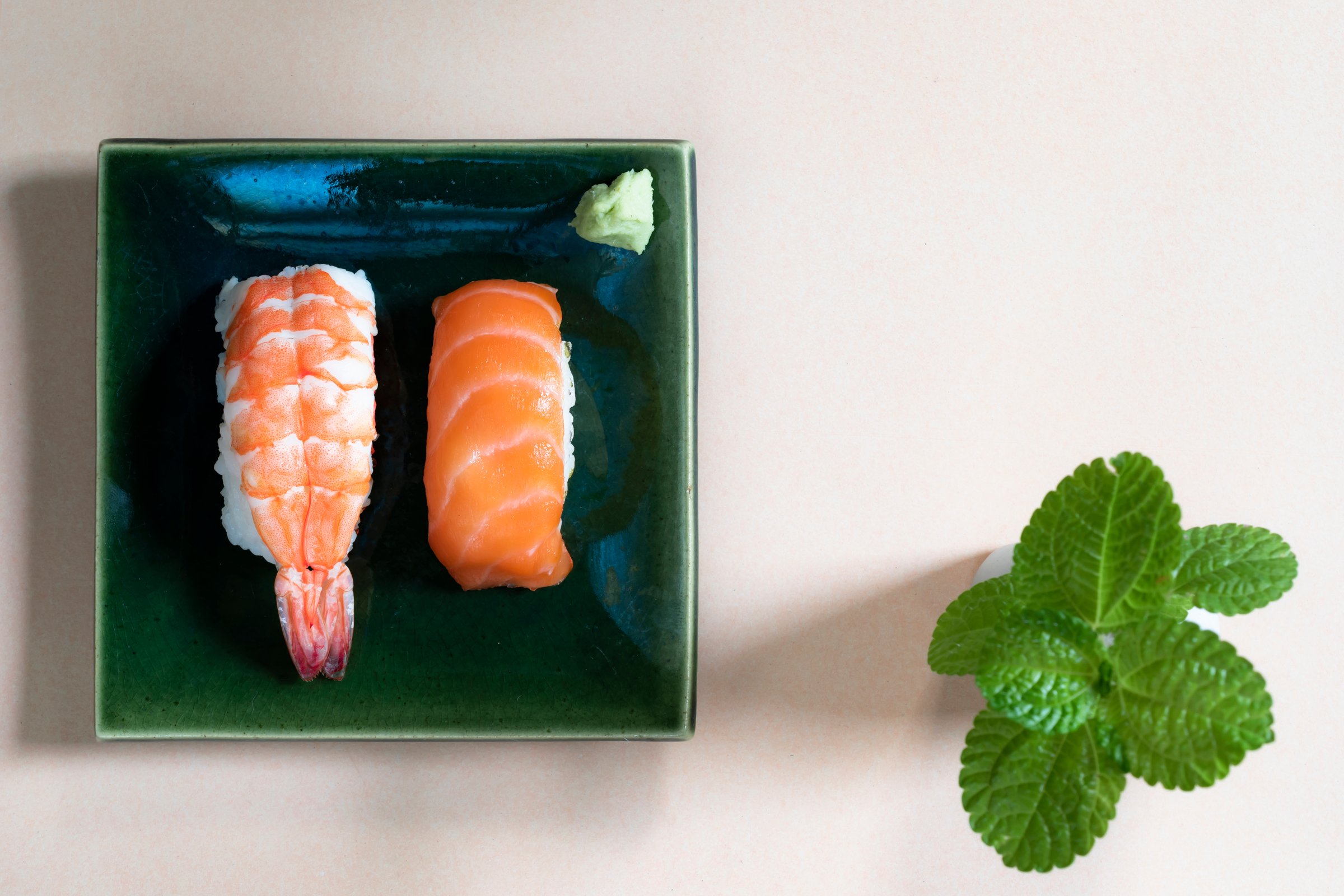 Sushi nigiri set in plate on wood bacground has chopstick close up, top view, Japanese food concept.