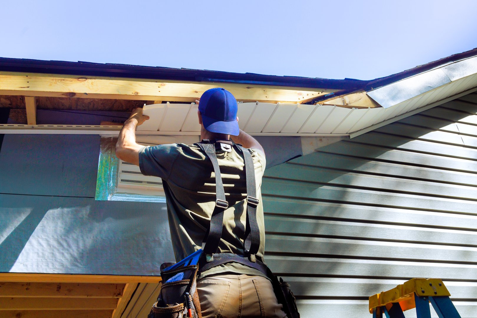 Plastic soffits mounted to roof rafters on house with cathedral ceiling