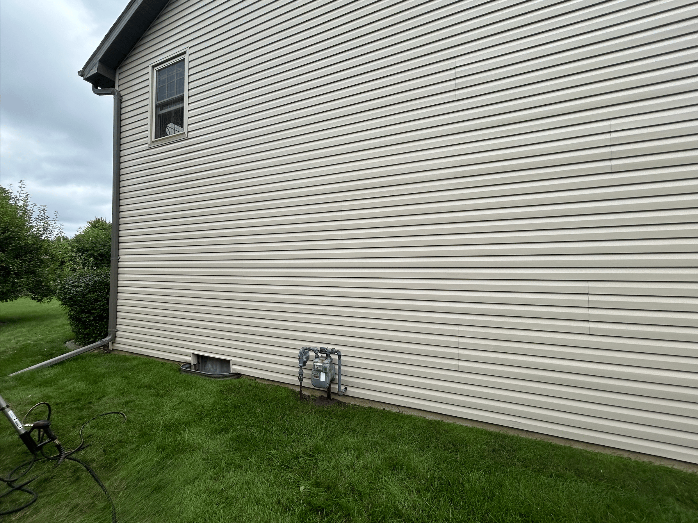 House exterior after pressure washing showing clean and renewed surface