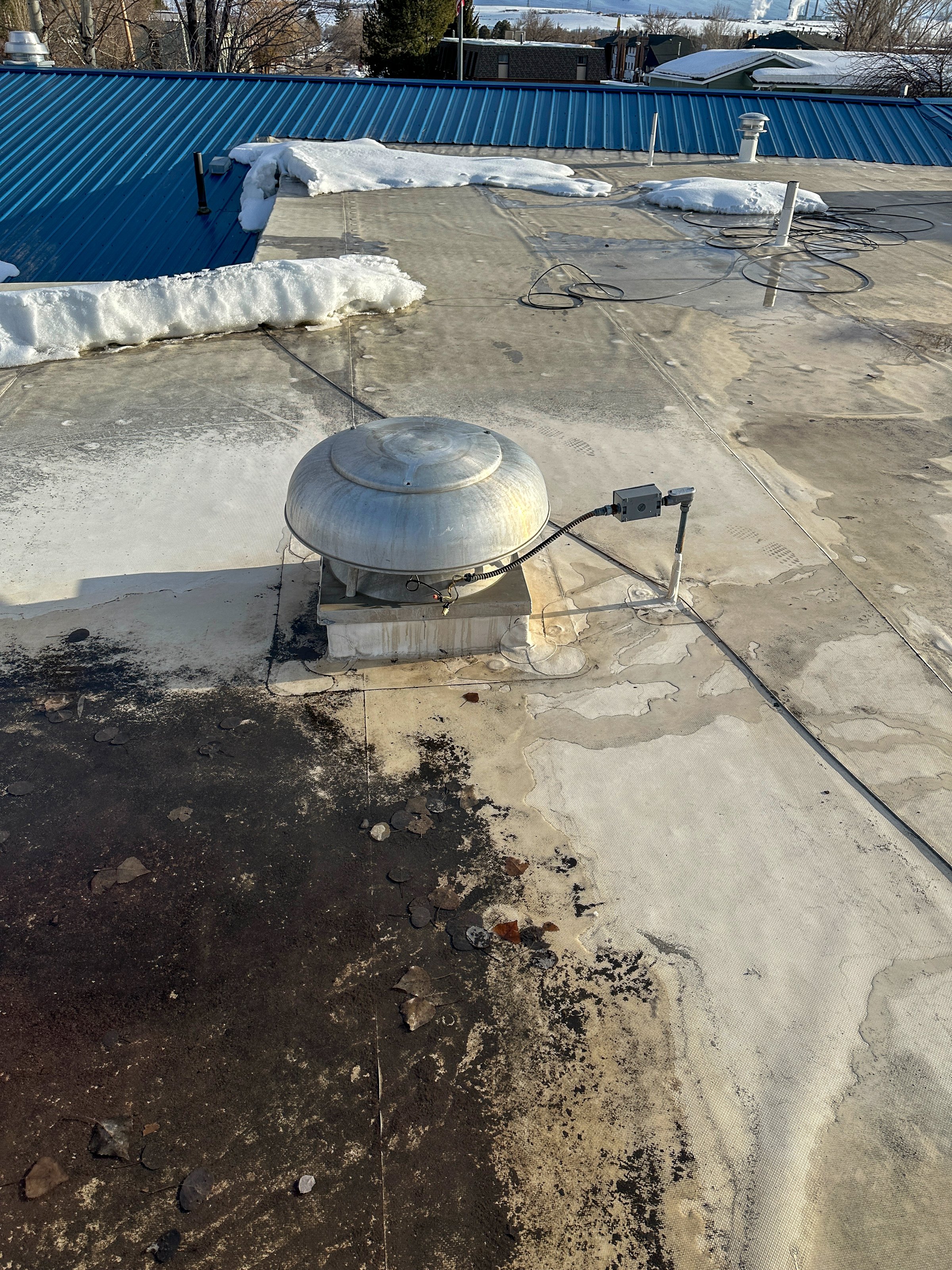 A kitchen exhaust fan on the roof of a building to aid in airflow to the kitchen bellow