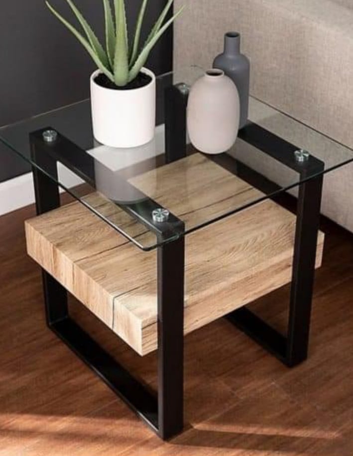 Modern side table with glass top, wooden shelf, black metal legs, and decorative vases, on a hardwood floor.
