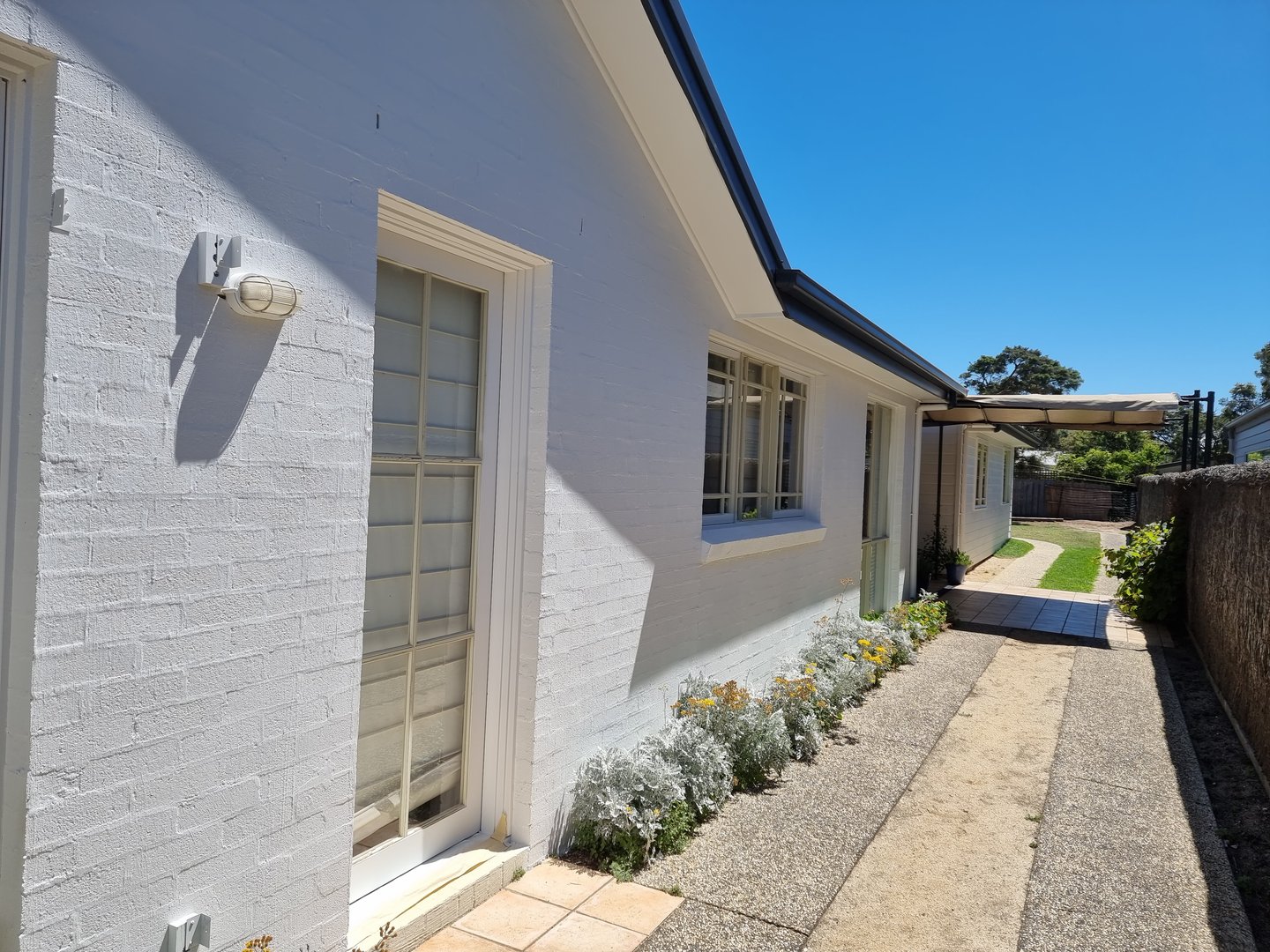 Quality Painting Group estate project progress photo showing detailed painting work in process