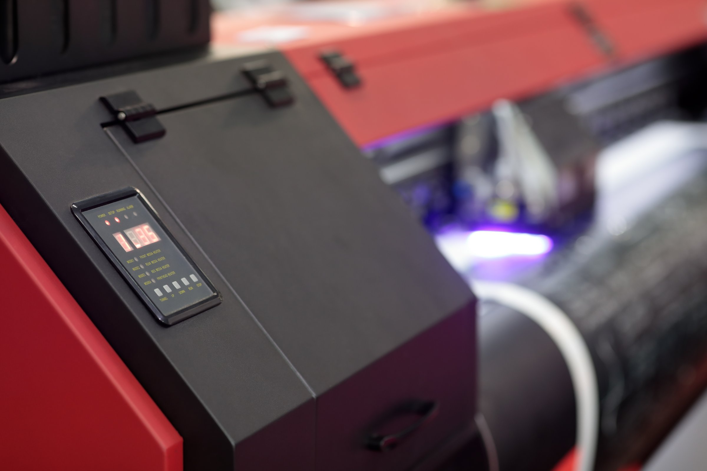 Control panel of large format UV roll to roll printer. Selective focus.