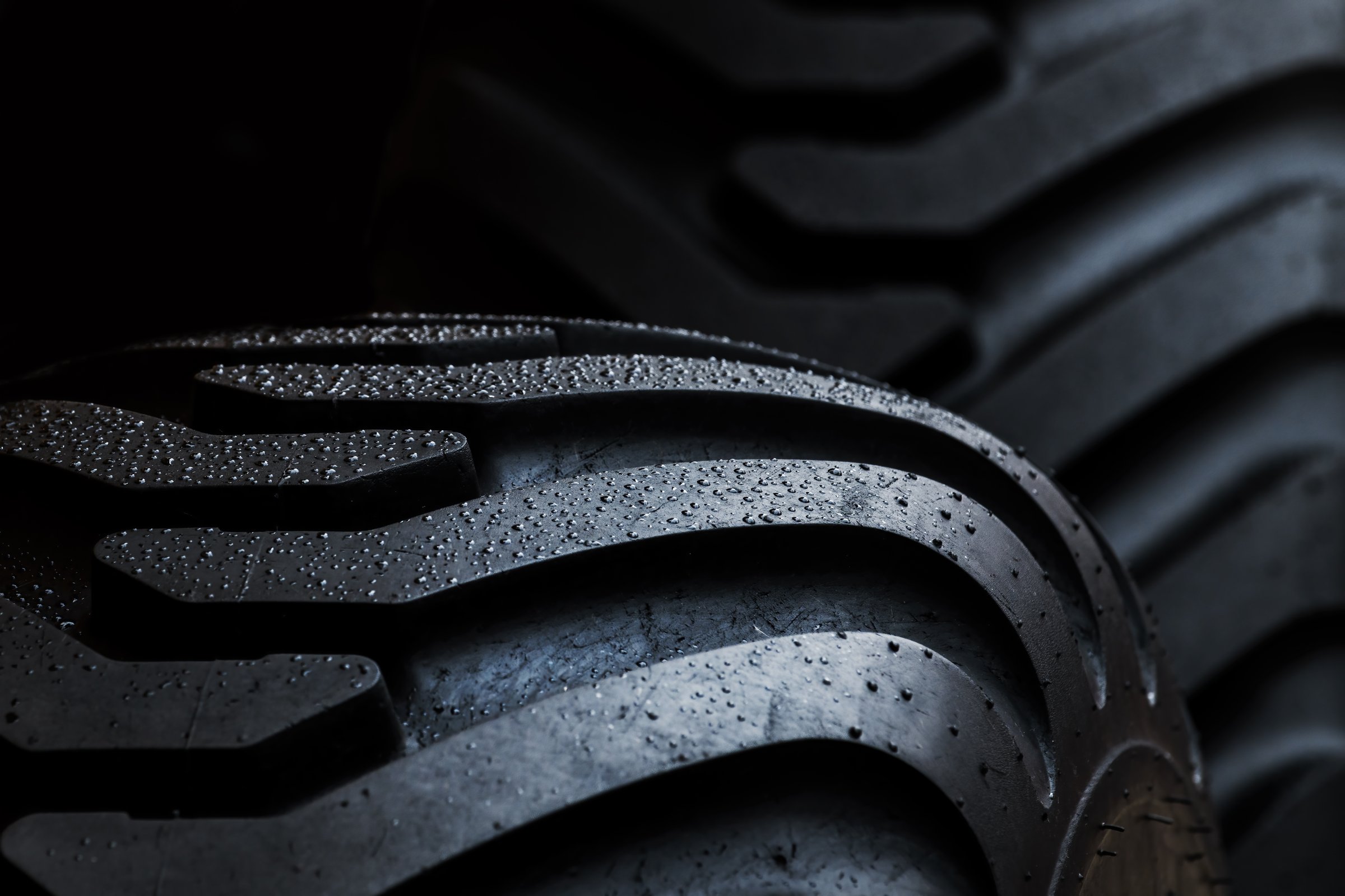 Closeup of agricultural tractor tire, farming vehicle tyre pattern, selective focus