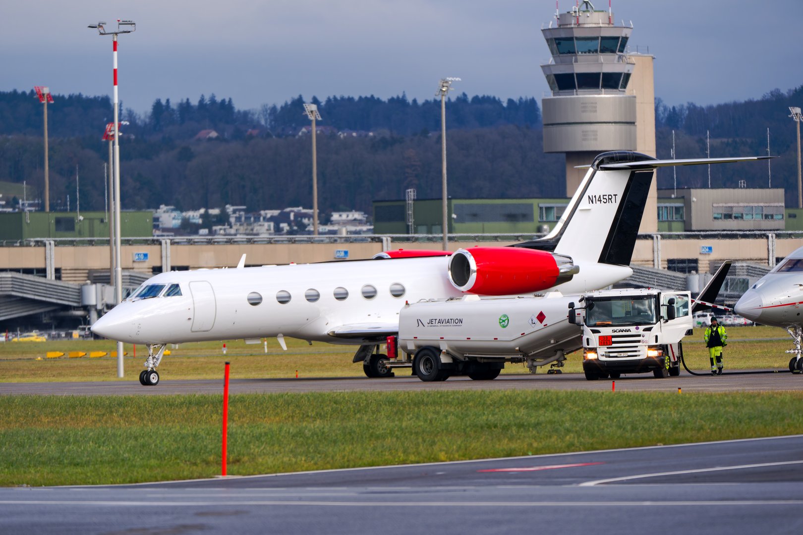 Parked private jet Gulfstream IV N145RT because of World Economic Forum WEF at Swiss Airport Zürich Kloten on a foggy winter day. Photo taken January 23rd, 2025, Zurich Kloten, Switzerland.