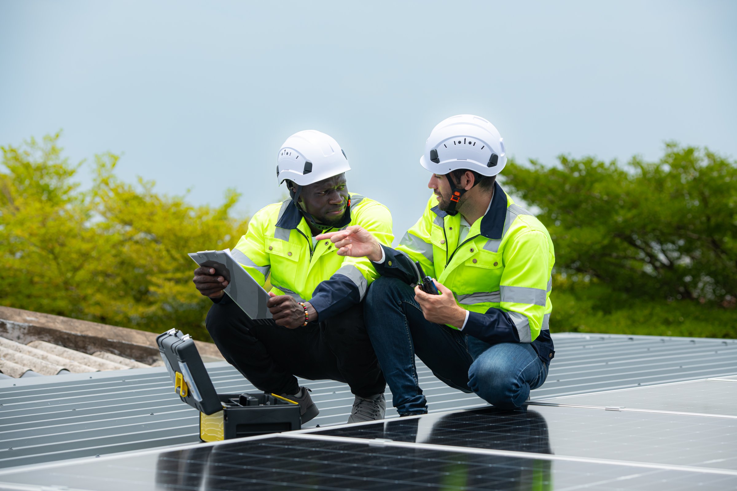 Engineer and technician inspects solar panel installation and test the operation of the panel