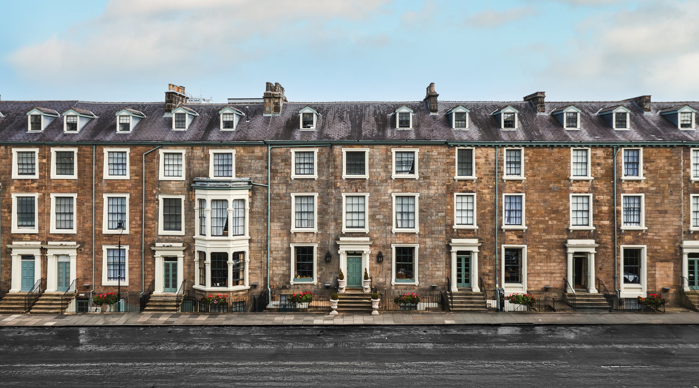 Panoramic view of exclusive four storey Victorian townhouses in an exclusive area of a UK city called Millionaire's Row with copy space