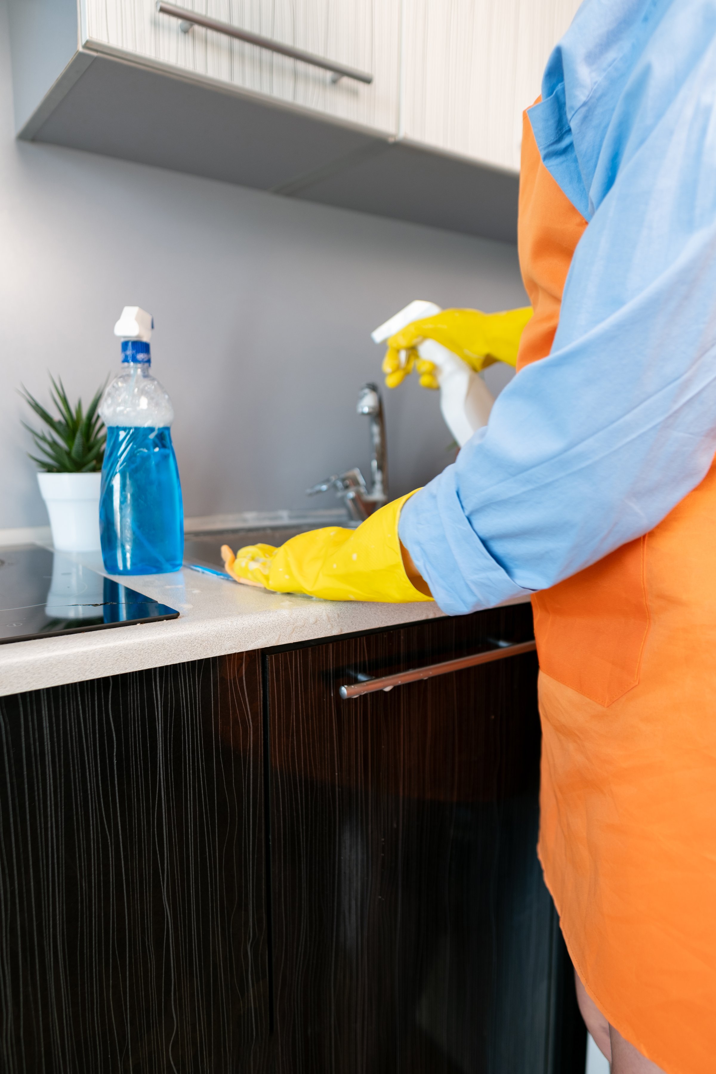 Perfect cleanliness with minimal effort. Woman cleans the sink using an effective cleaner, leaving no trace of dirt behind.