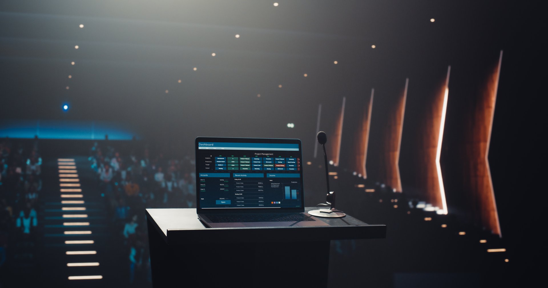 Establishing Shot with a Laptop Computer Screen Showing Business Analytics on Display. Device Standing on a Tribune on Stage, with a Crowded Conference Hall Before a Technology Presentation