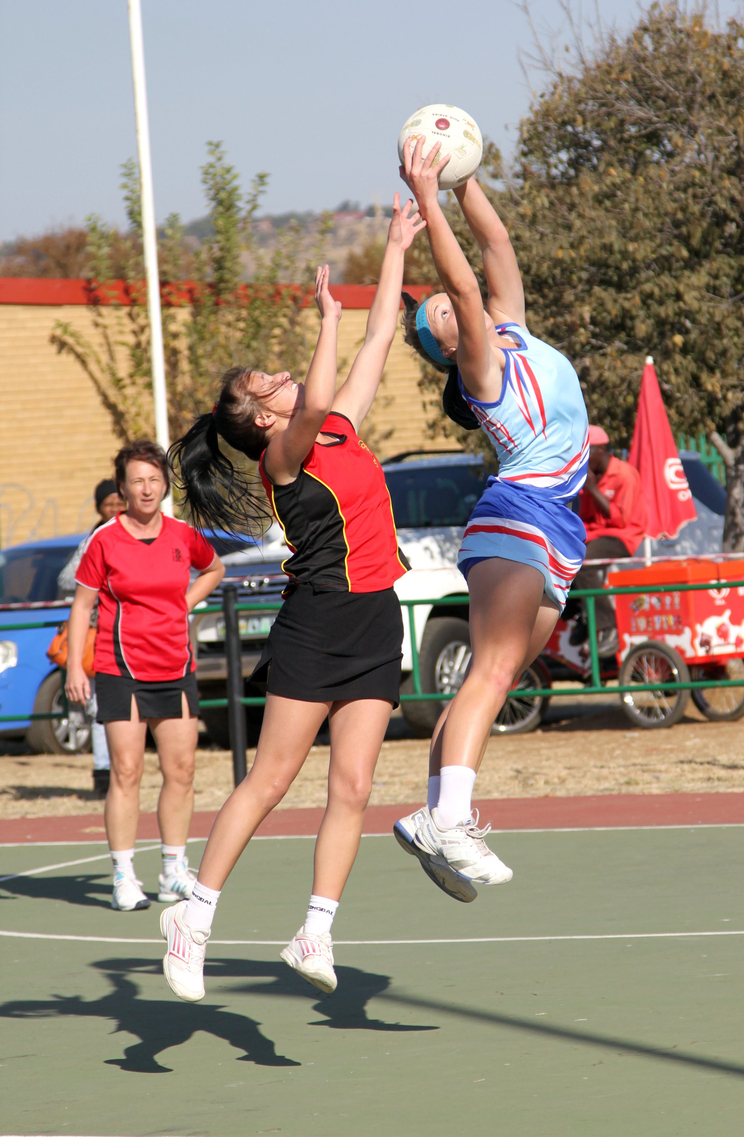 Rustenburg, South Africa - June 6, 2015:  Korfball League games played at Olympia Park.  Ladies team:  Girl catching ball.