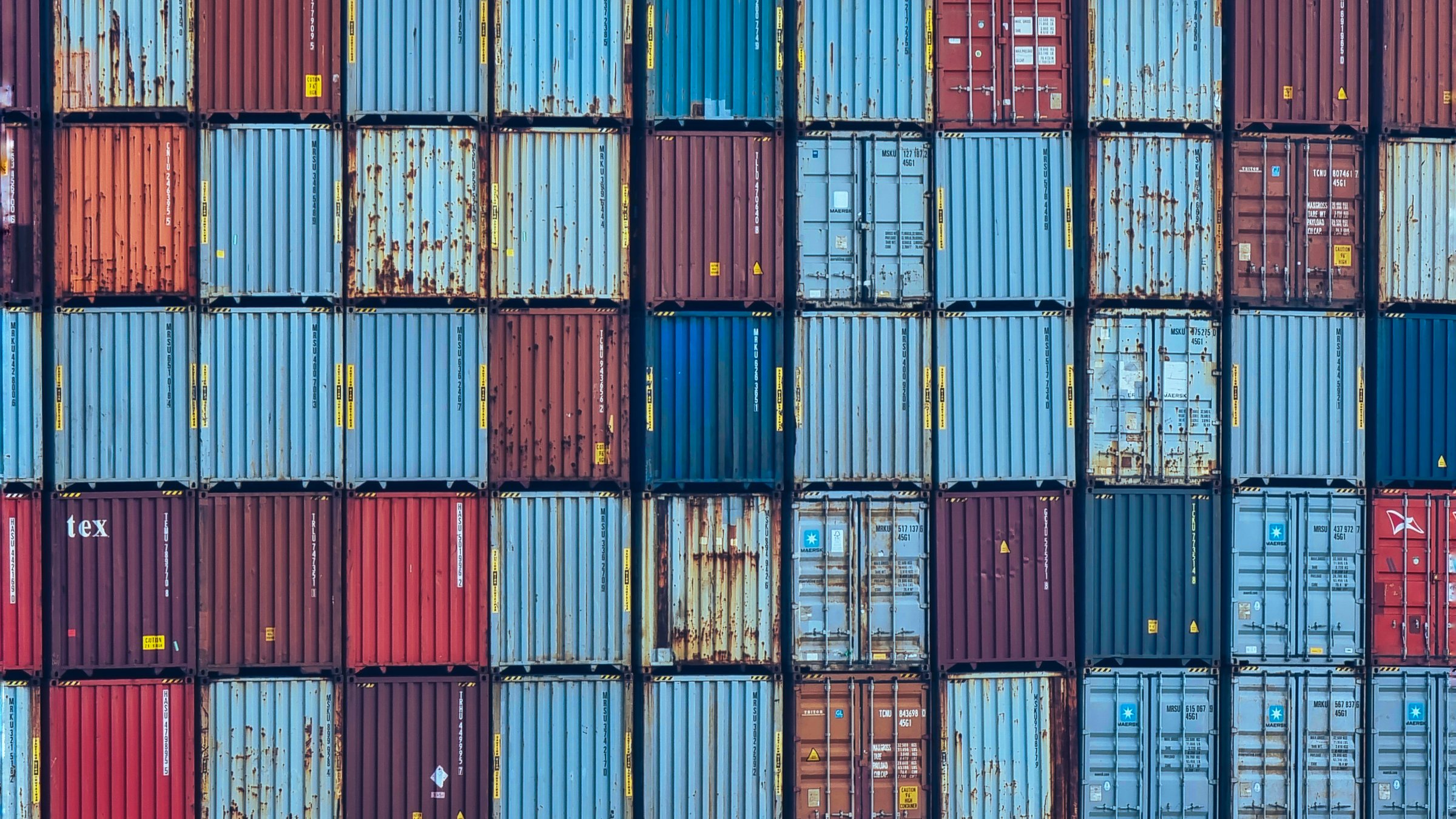 A high-resolution image showcasing a seamless pattern of stacked cargo containers