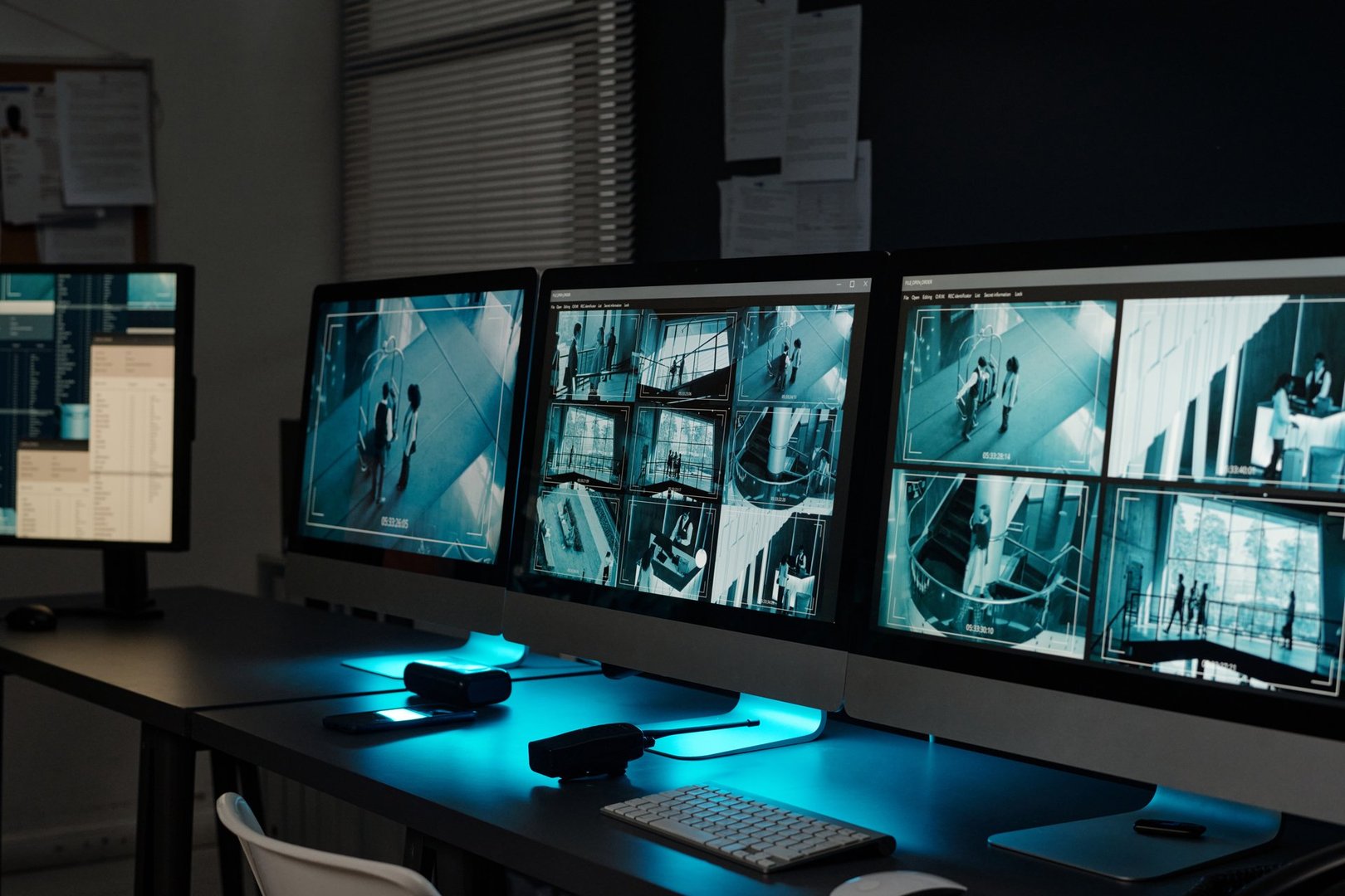 Workplace of absent officer of observation room with group of desktop computer monitors with cctv video system