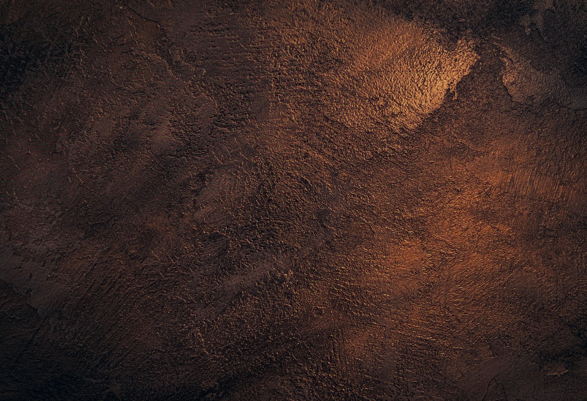 dark bronze plastered wall covered with decorative stucco
