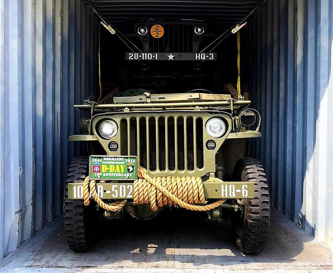 Luxury vehicle being transported in enclosed carrier