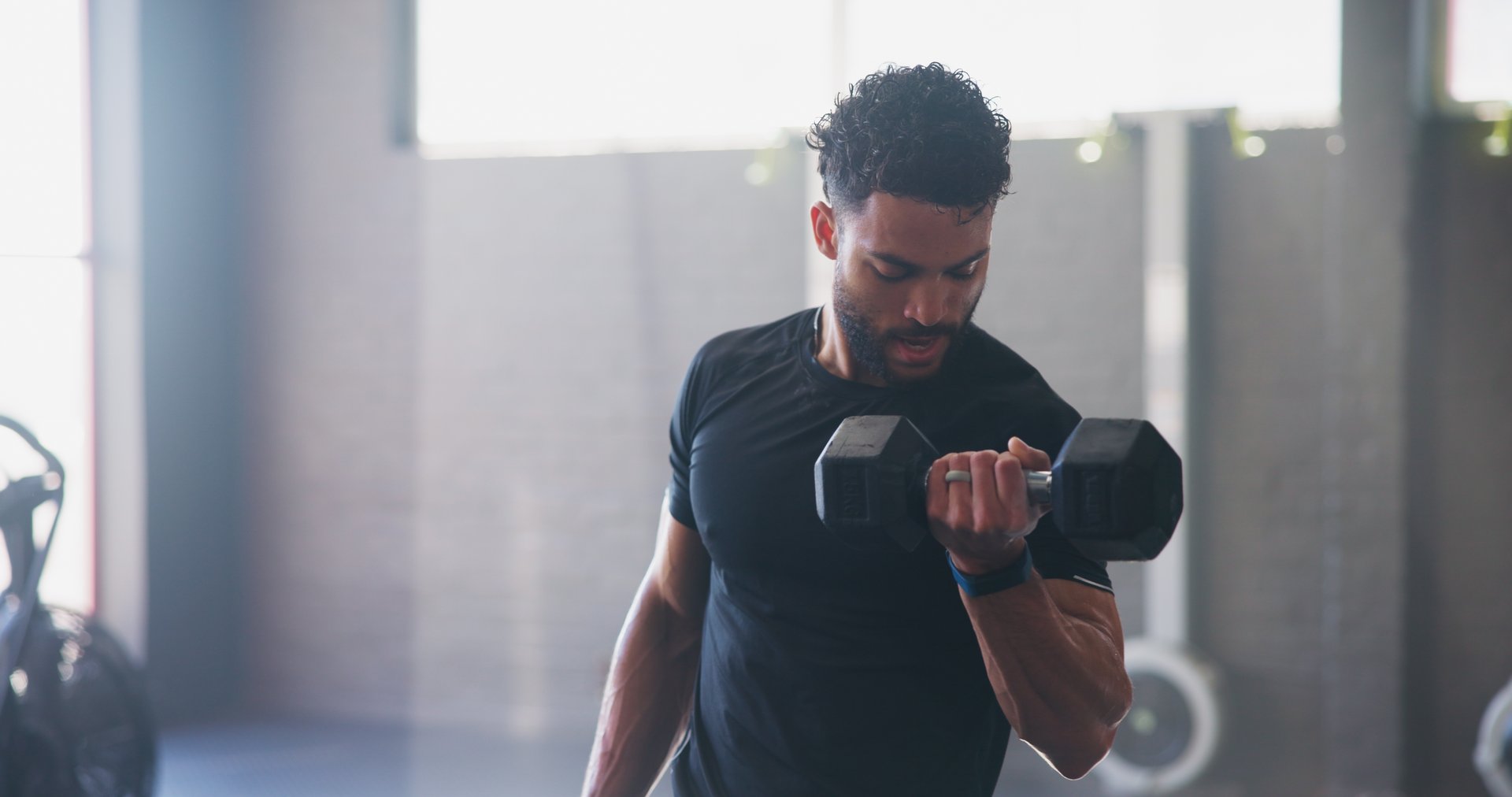 Fitness, man or dumbbell in gym for weightlifting, strong arm muscle development or intense workout. Body builder, exercise or sweating with weight for strength training, commitment or sport activity