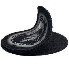 A warped vinyl record with a partially melted appearance, resting on a flat surface.