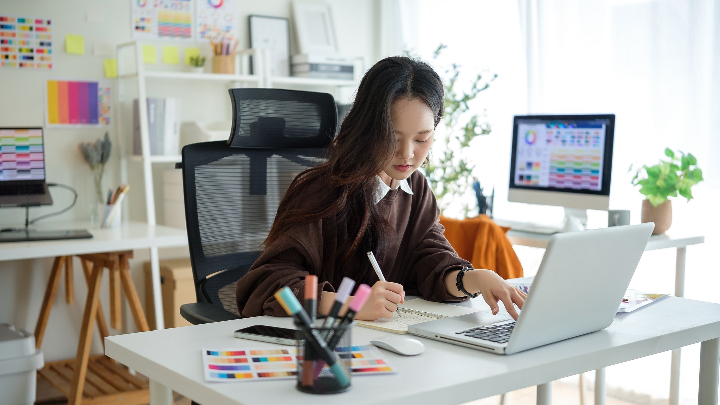 Young graphic designer focused on project in creative studio.