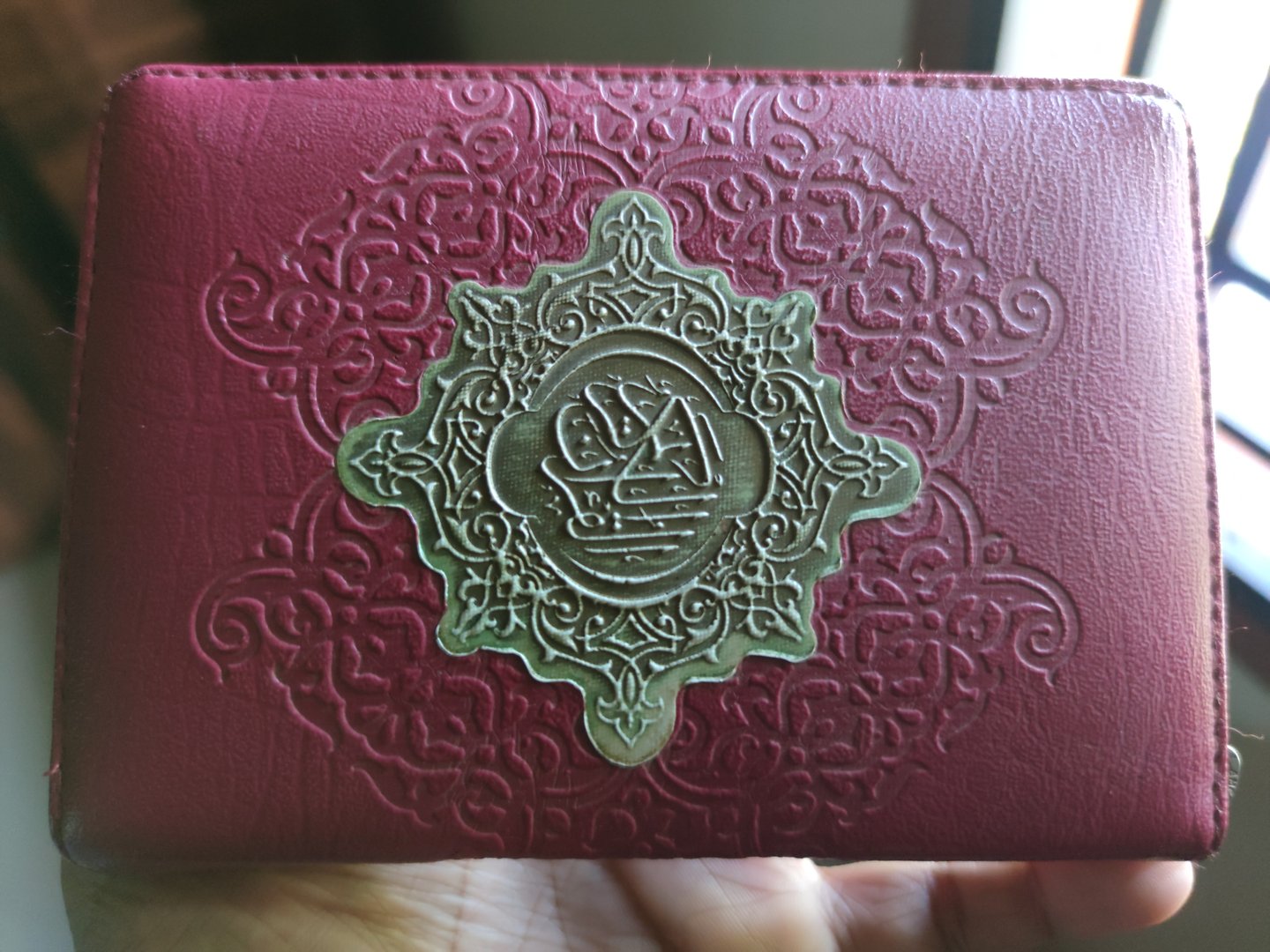 outer cover of the Koran with embossed writing