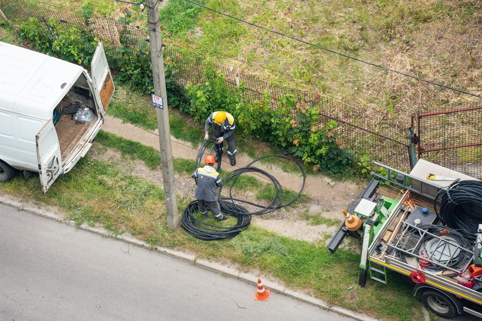 Bila Tserkva, Ukraine, June 22, 2025: Electricians are pulling power transmission cables