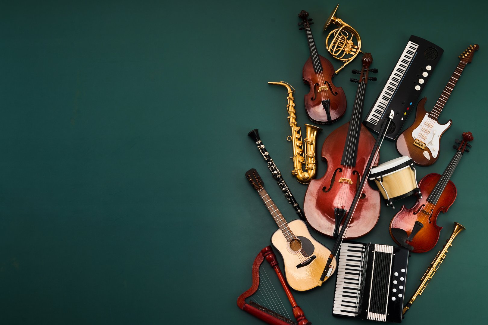 Collection of various musical instruments on a dark green background
