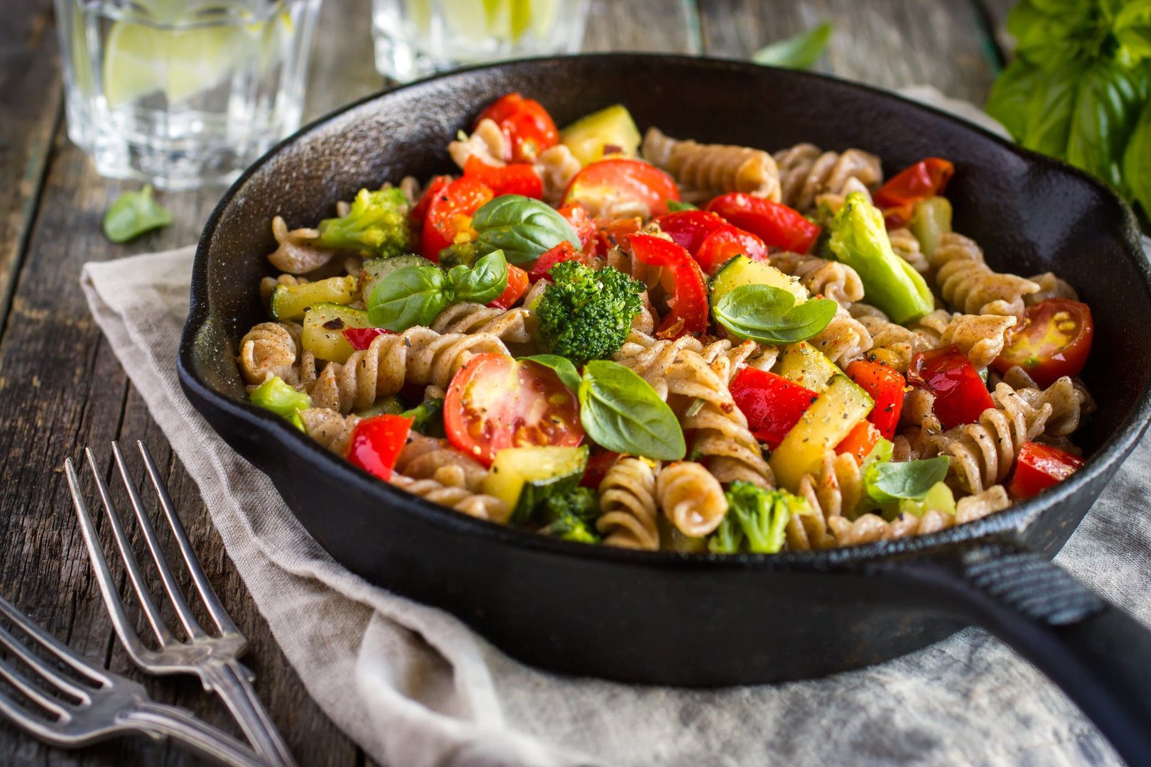 Whole wheat pasta with vegetables on cast iron pan