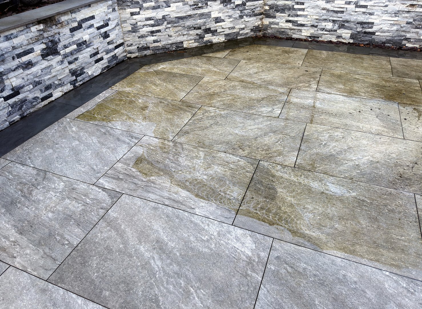 Professional power washing results - clean and revitalized patio surface