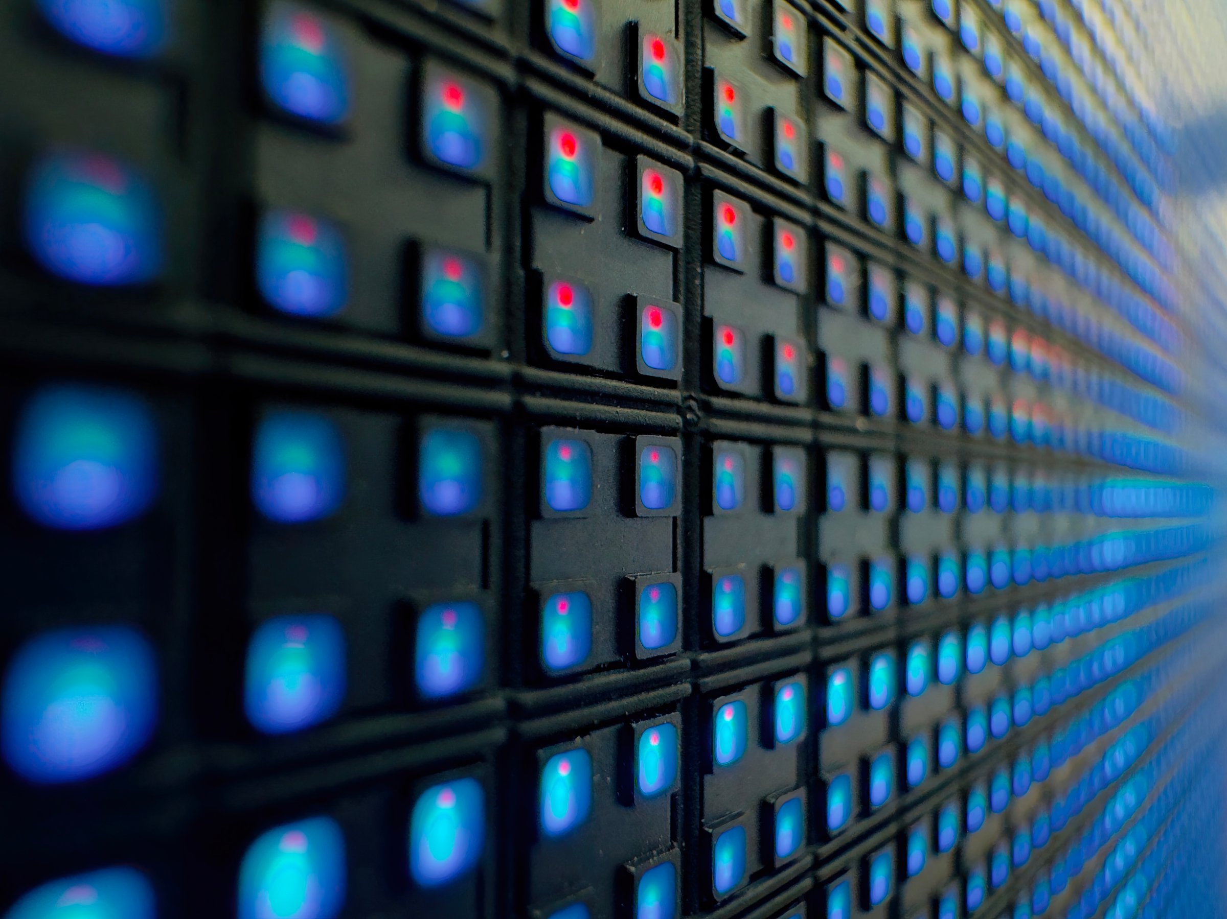 Closeup of an LED Wall showing a grid of red and blue diodes glowing against a dark background, emphasizing digital technology and modern electronics