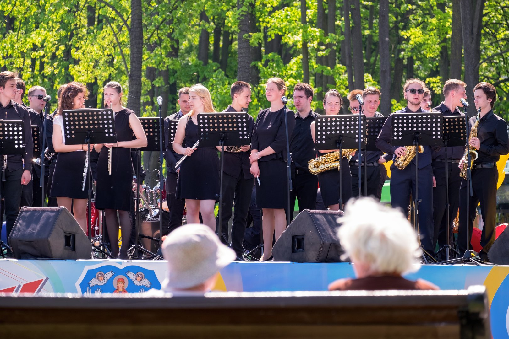 Minsk, Belarus - May 09, 2018: A brass band of young musicians is preparing for an outdoor performance. The audience is elderly women. Spring. Minsk (Belarus). May 9, 2018.