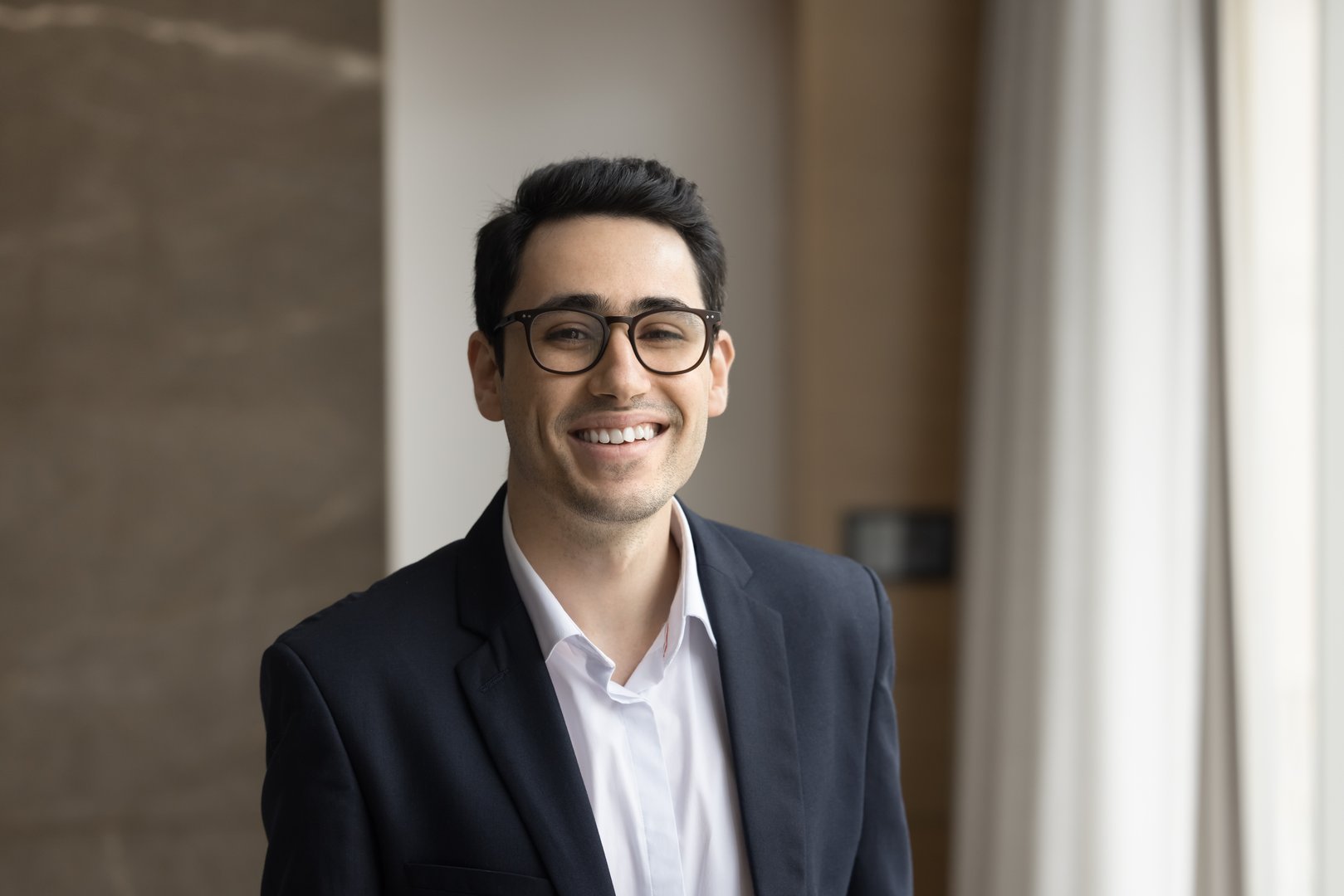 Profile picture of smiling confident Arabic businessman in formal jacket looking at camera for corporate album. Head shot portrait of company male boss or trainer, business achievements, career growth