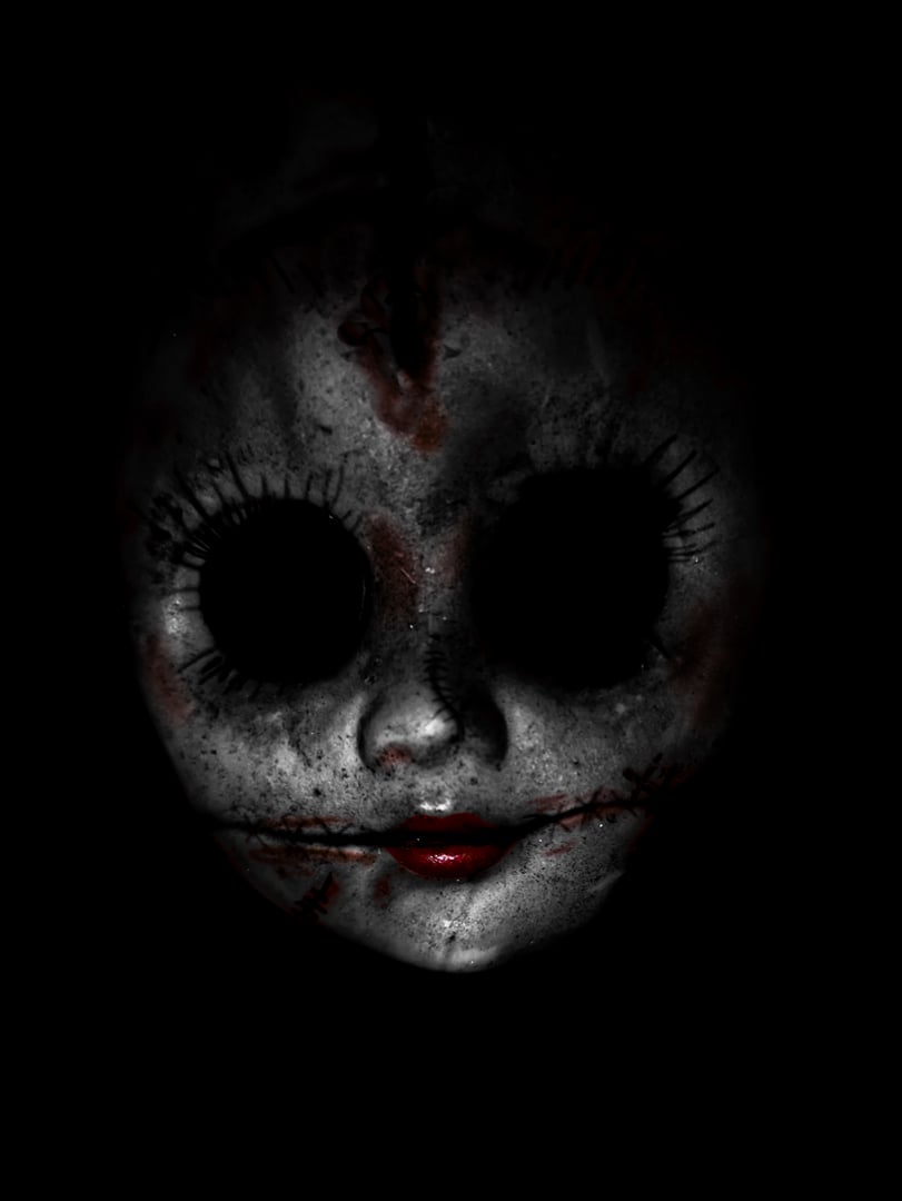 Creepy doll face in the dark