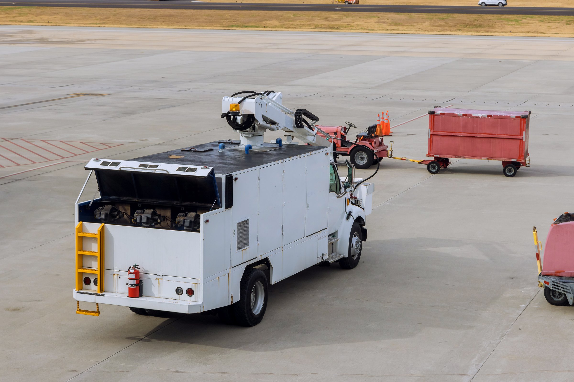 Electromobile transport at the airport runway on conveyor truck