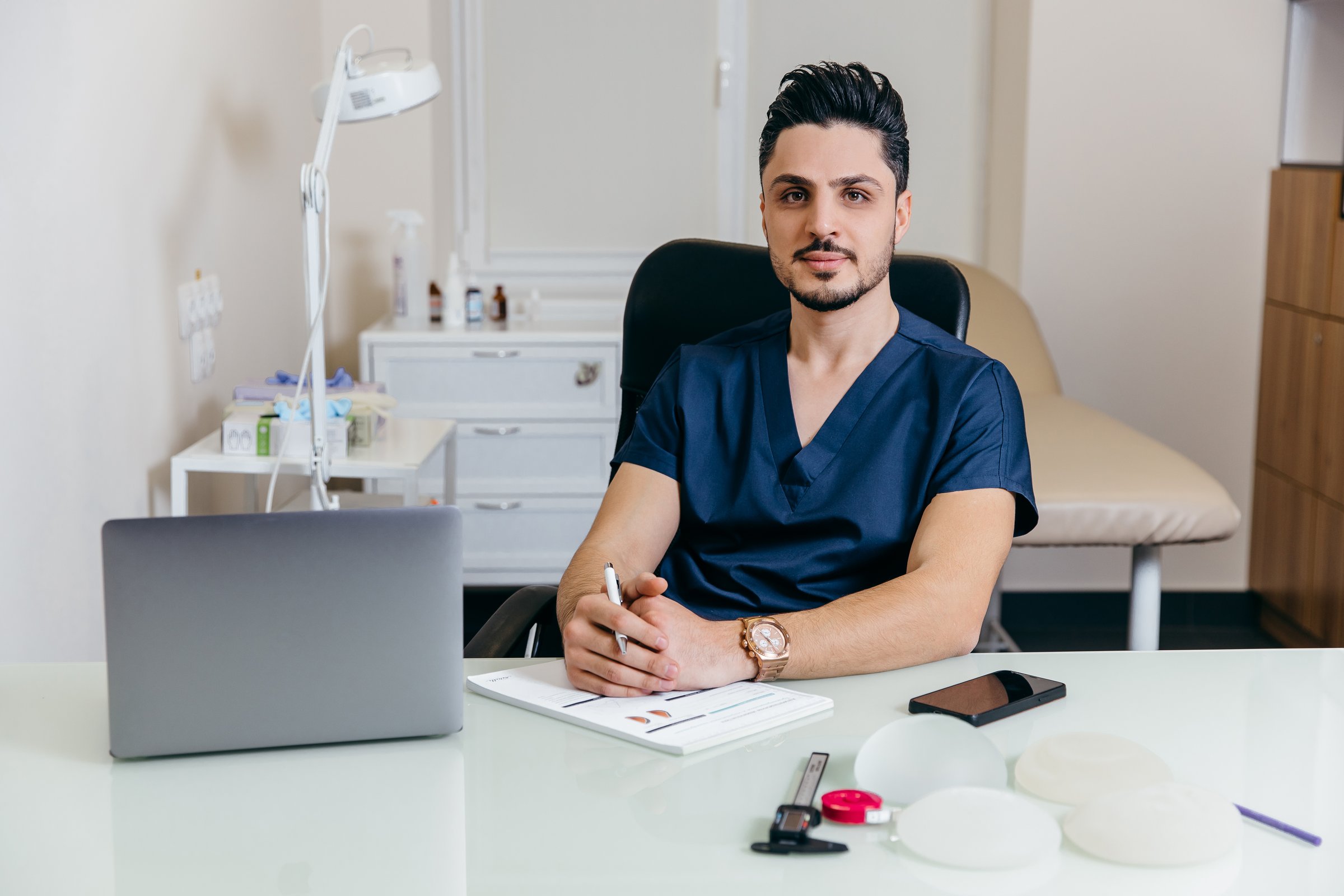A young arabic or turkish doctor in a blue uniform conducts online counseling. High quality photo