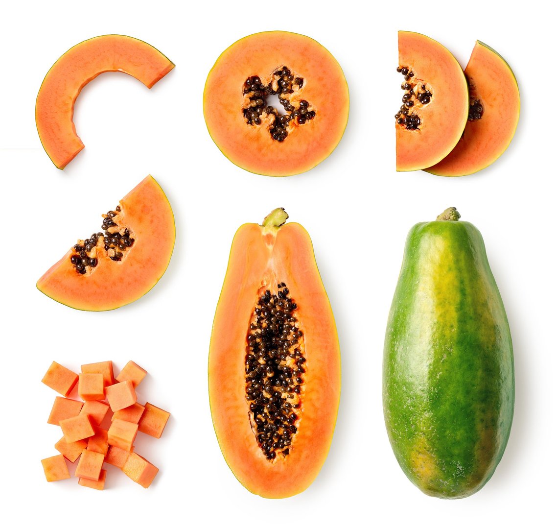 Set of fresh whole and half papaya fruit and slices isolated on white background