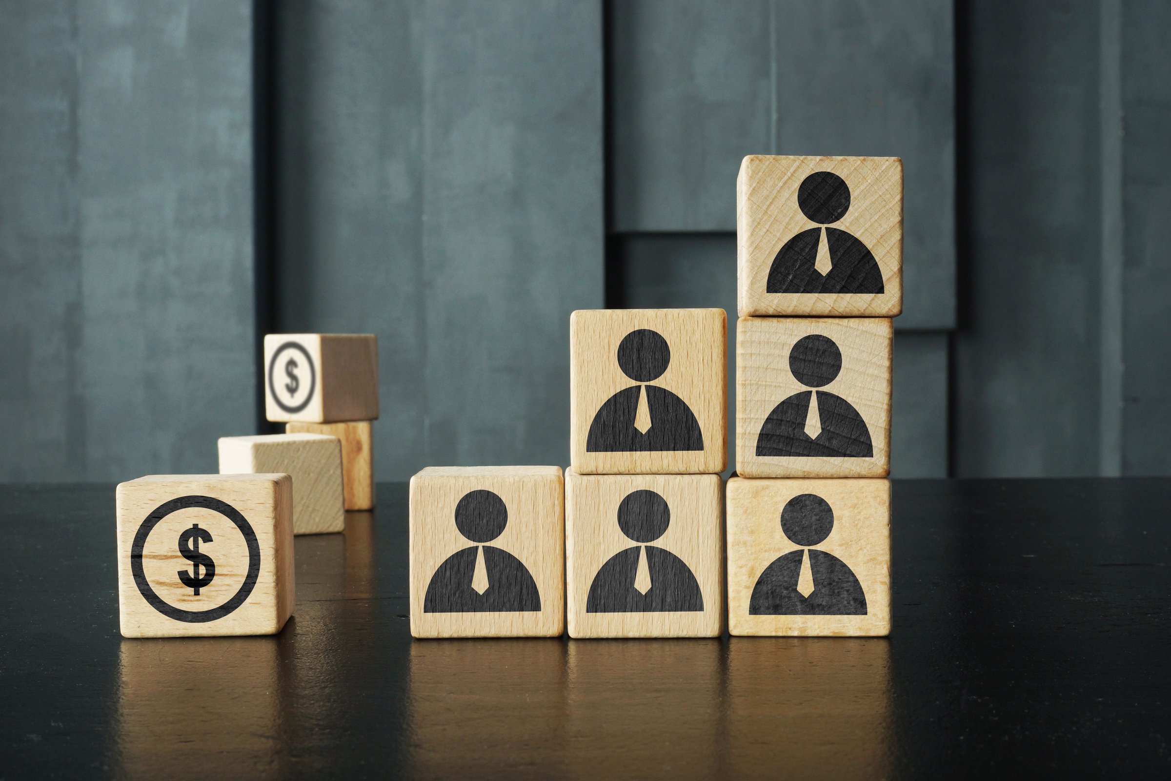 Multi Level Marketing MLM is shown using a pictures on a wooden cubes