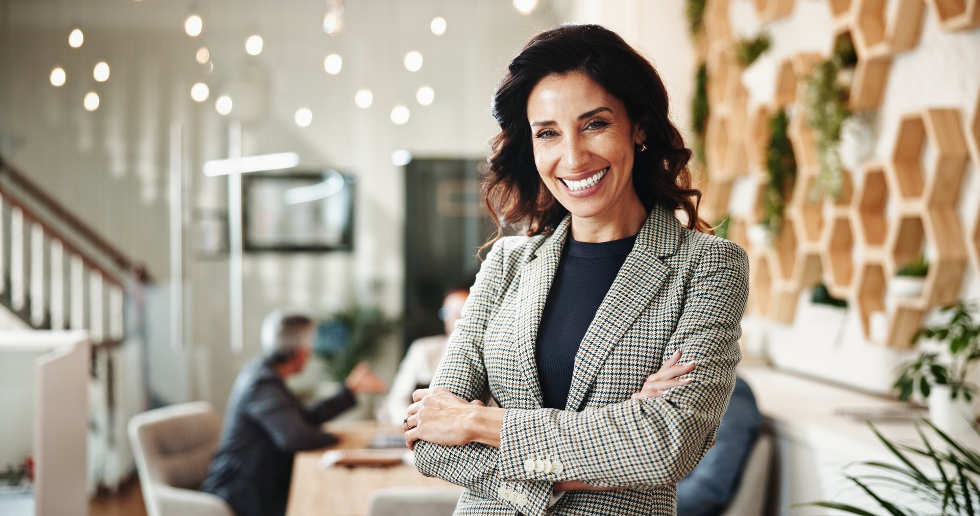 Portrait, confidence and happy business woman in office as sustainability manager or leader. Boss, arms crossed and professional worker in meeting, eco consultant and environmental policy advisor