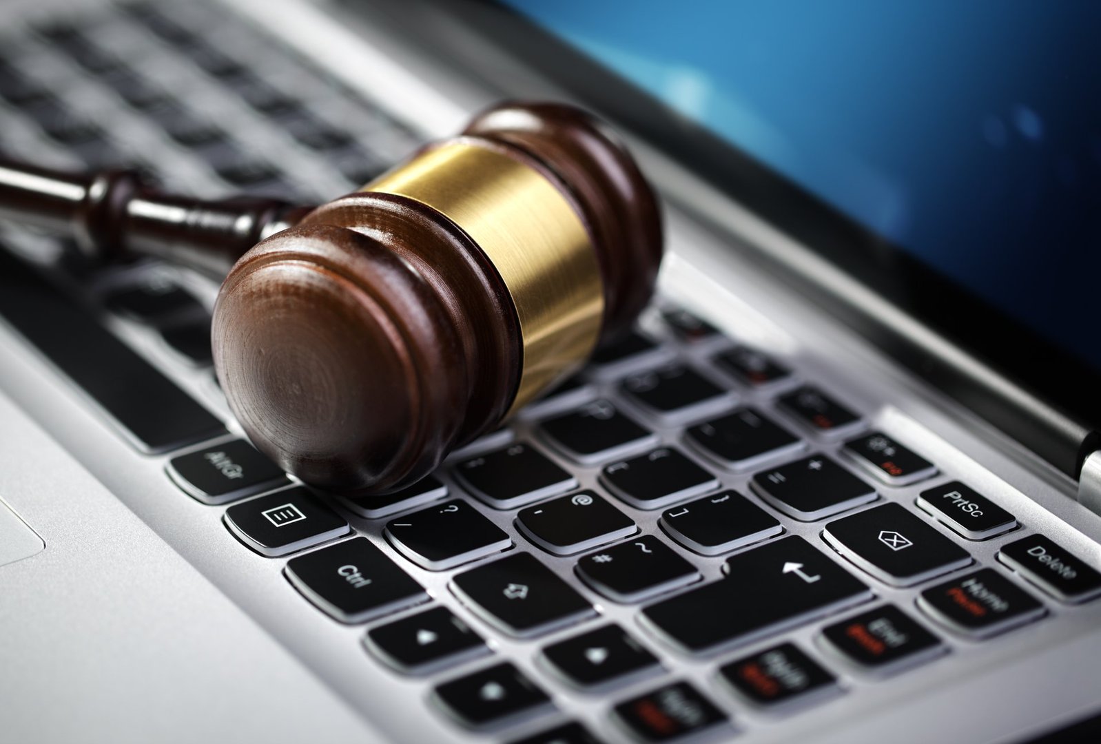 Gavel on laptop computer keyboard concept for online internet auction or legal assistance