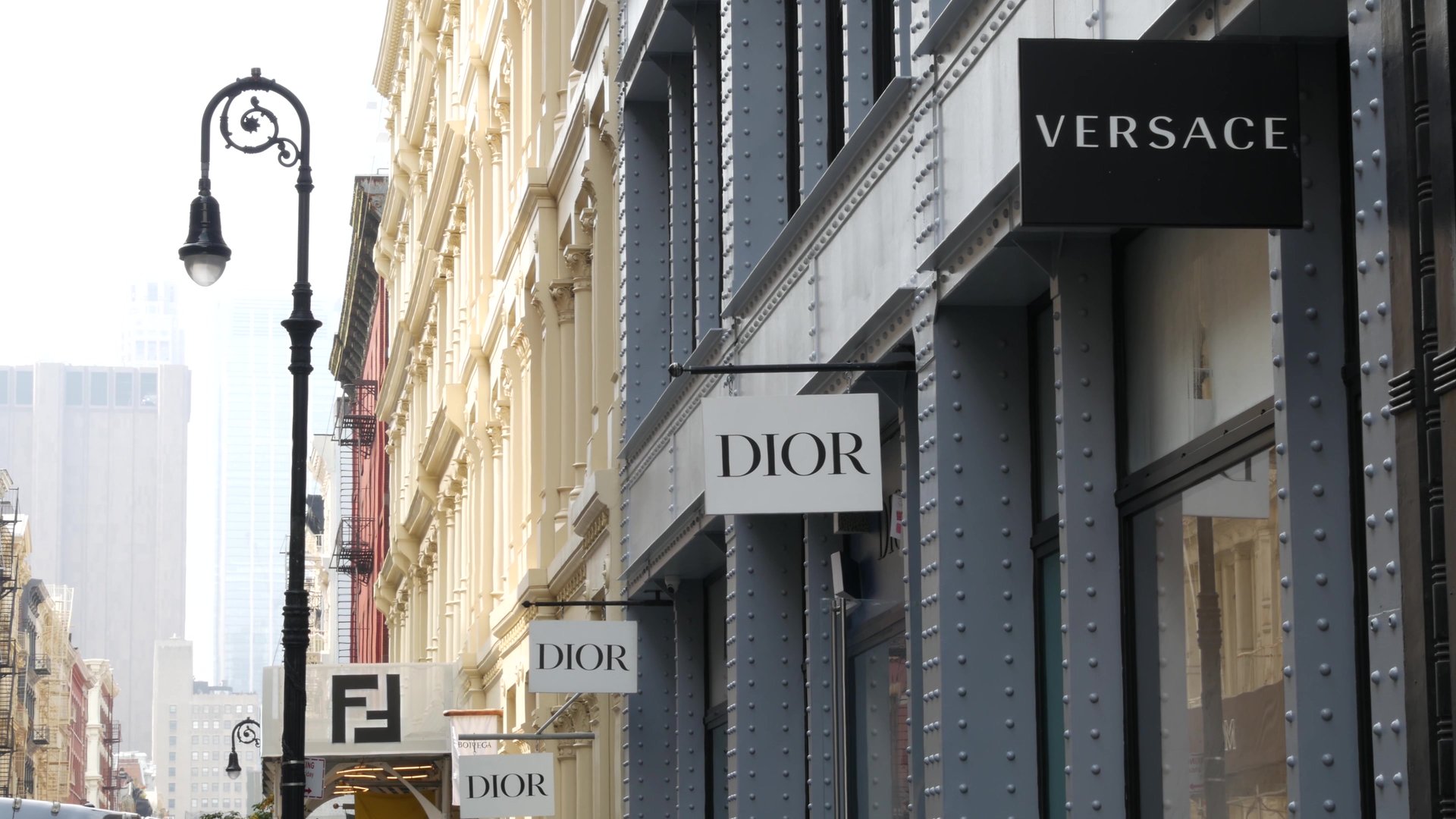 New York City, United States - 8 Sept 2023: Manhattan Soho fashion district near Broadway street, USA. Shopping boutique stores in NYC. Business and residential real estate. Dior, Versace brand logo.