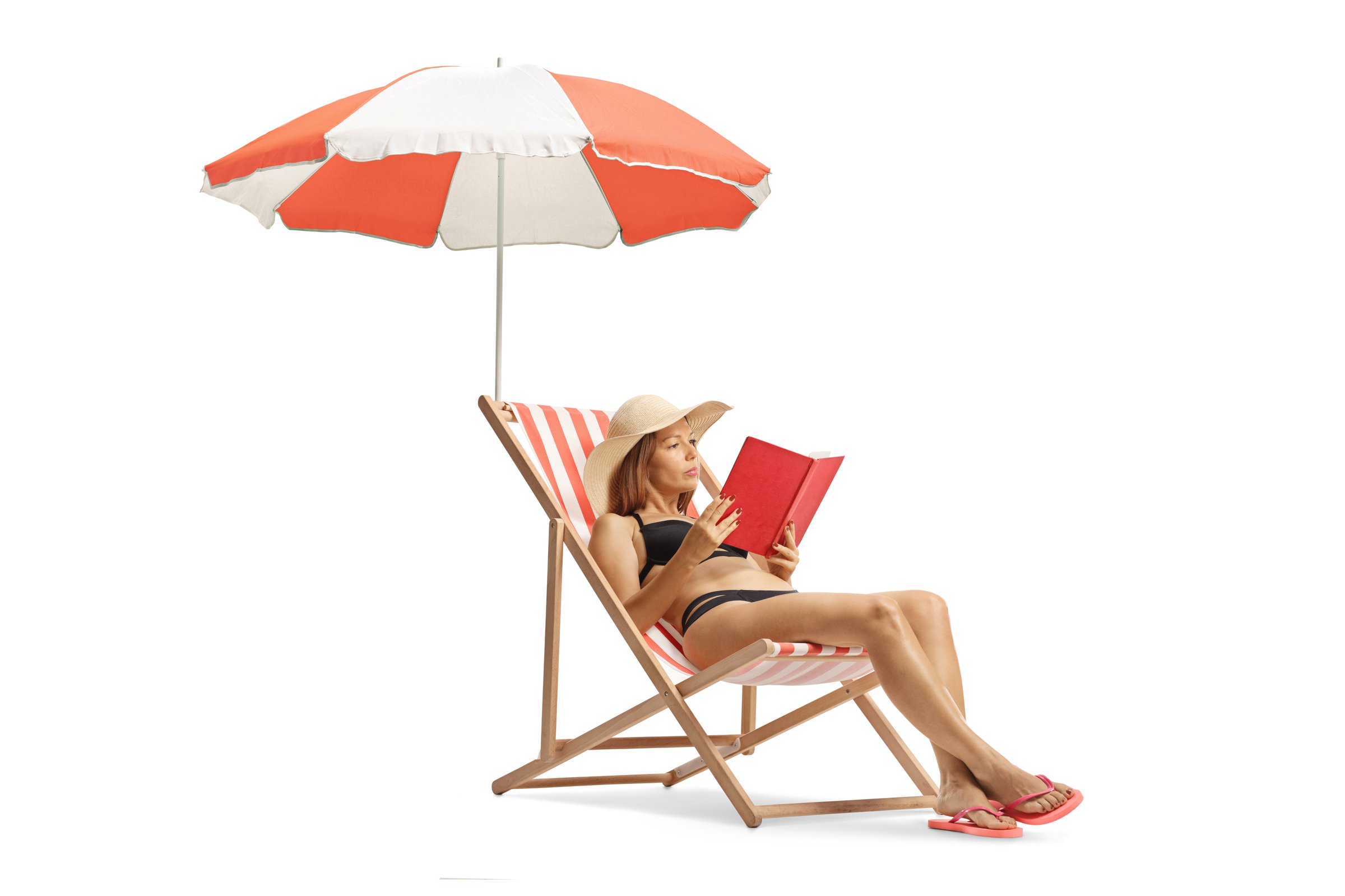 Young woman in bikini on a beach chair reading a book under umbrella isolated on white background