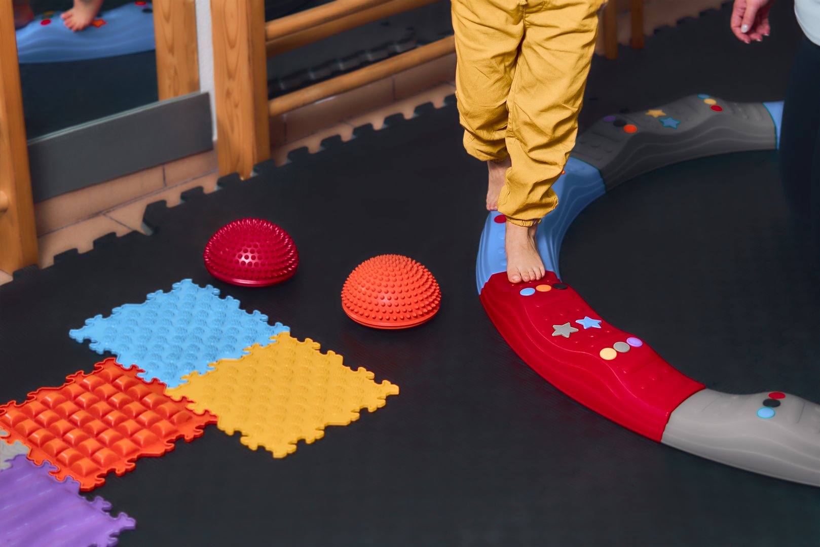 Child in rehabilitation centre with physiotherapist doing orthopedic correction.