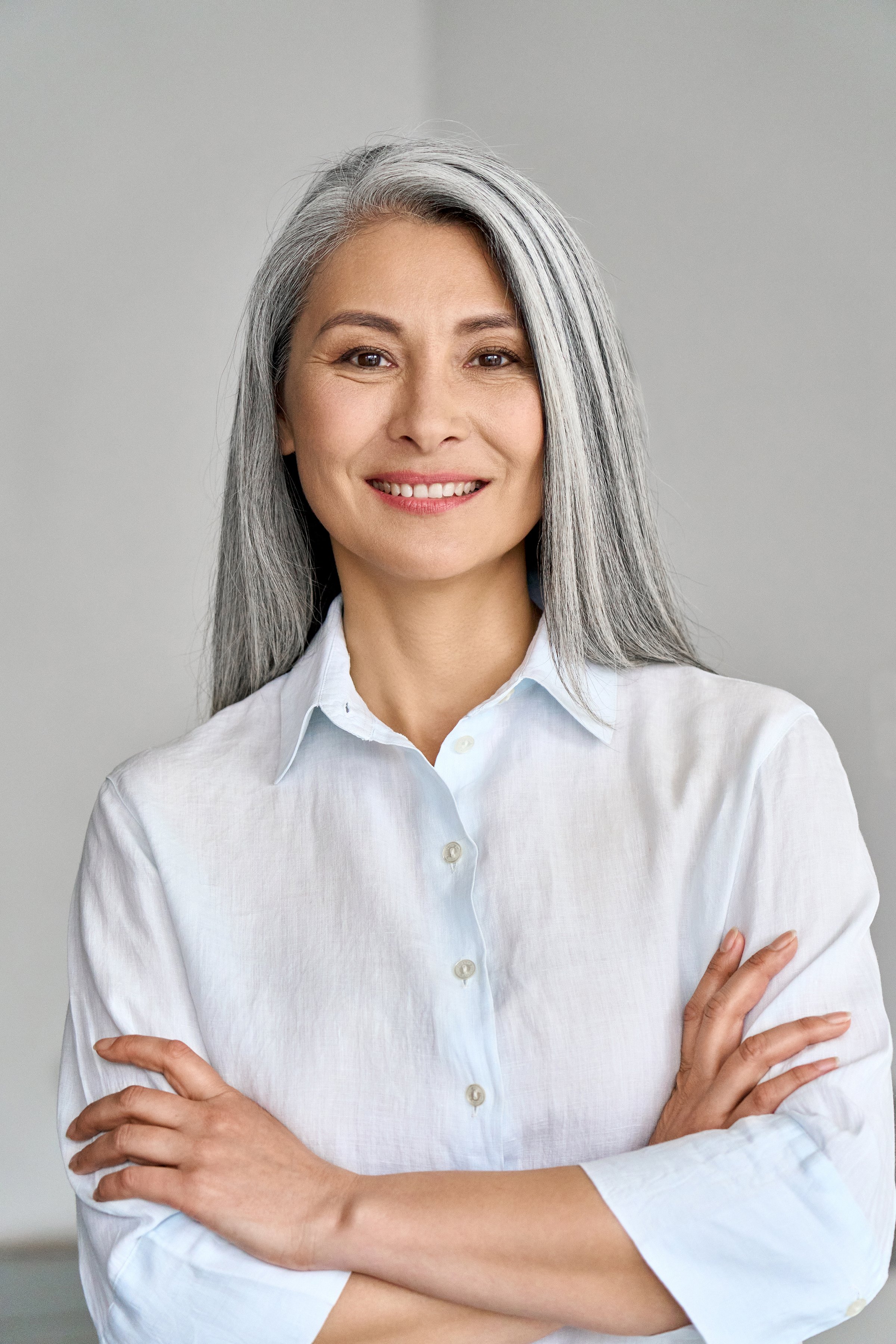 Confident adult Asian woman smiling