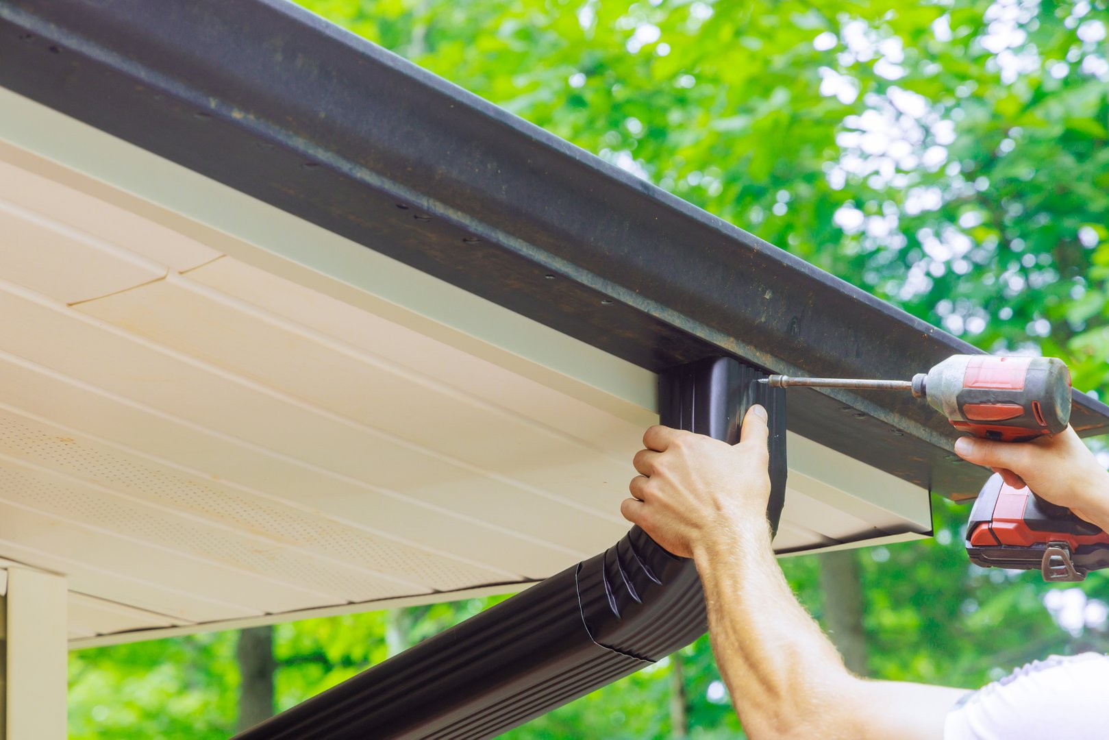 Assembling installing gutter channels on roof of home