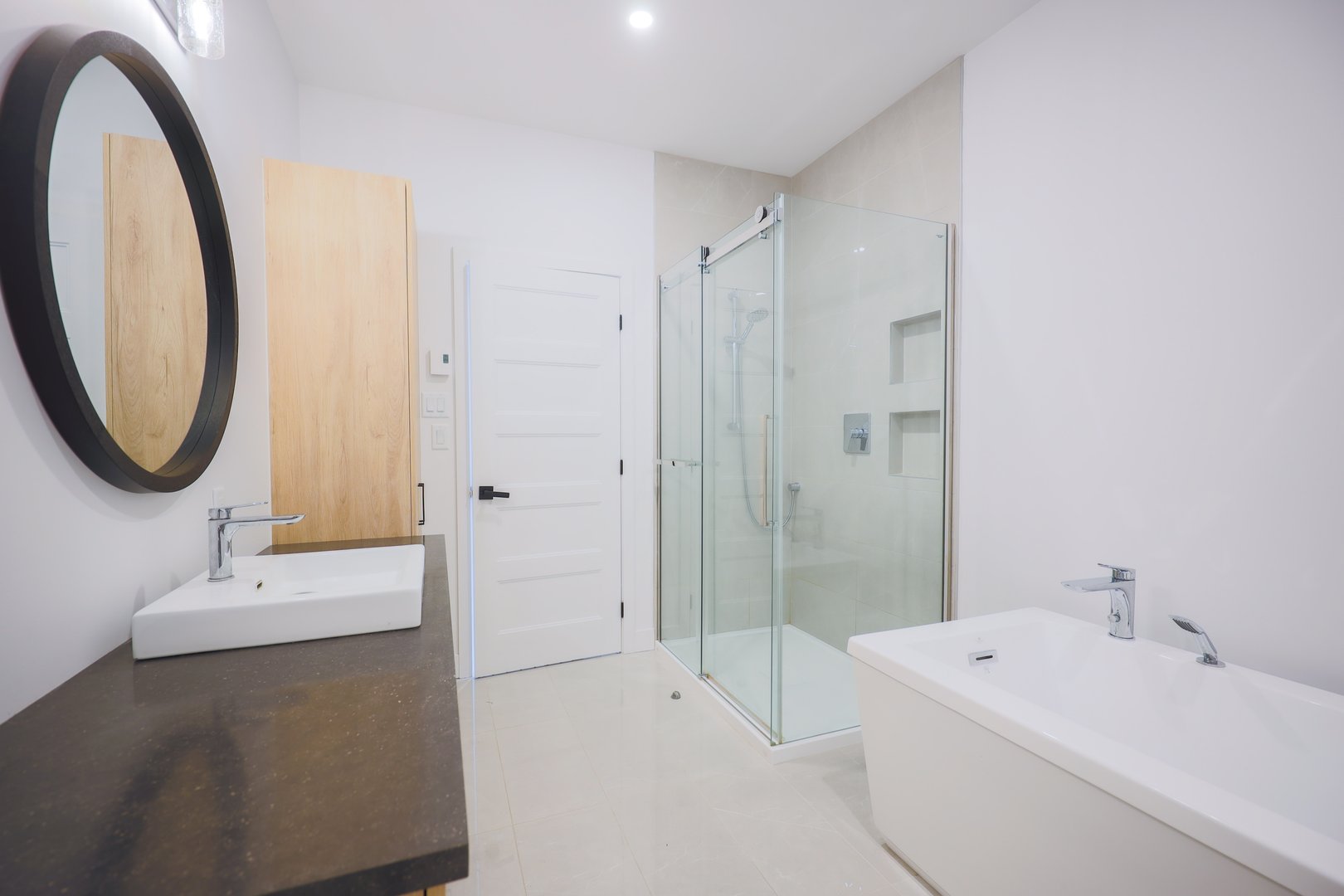 A clean, well-lit bathroom in a house, featuring modern fixtures and a minimalist design.