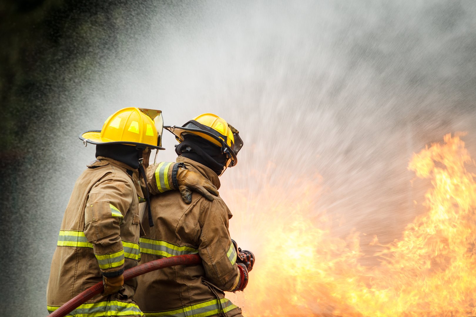 Firefighter using hose