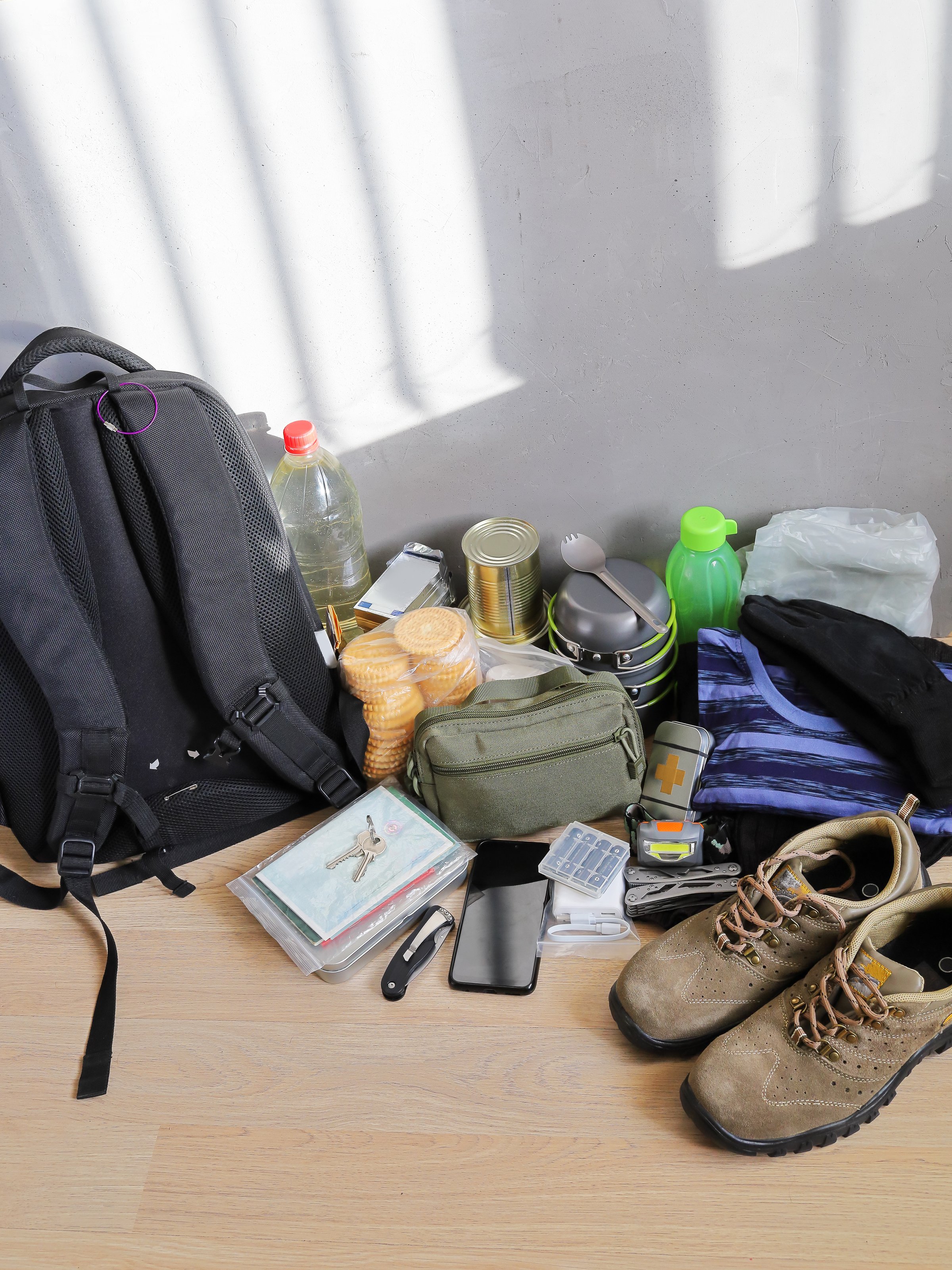 Survival set, backpack and necessary items in emergency and evacuation, vertical format with copy space