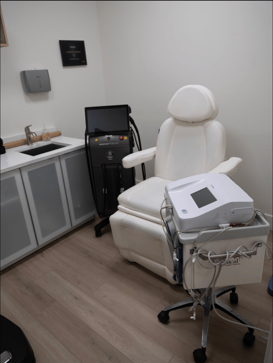 Elegant and minimalistic spa room interior with a treatment table, a ring light, and a serene ambiance.
