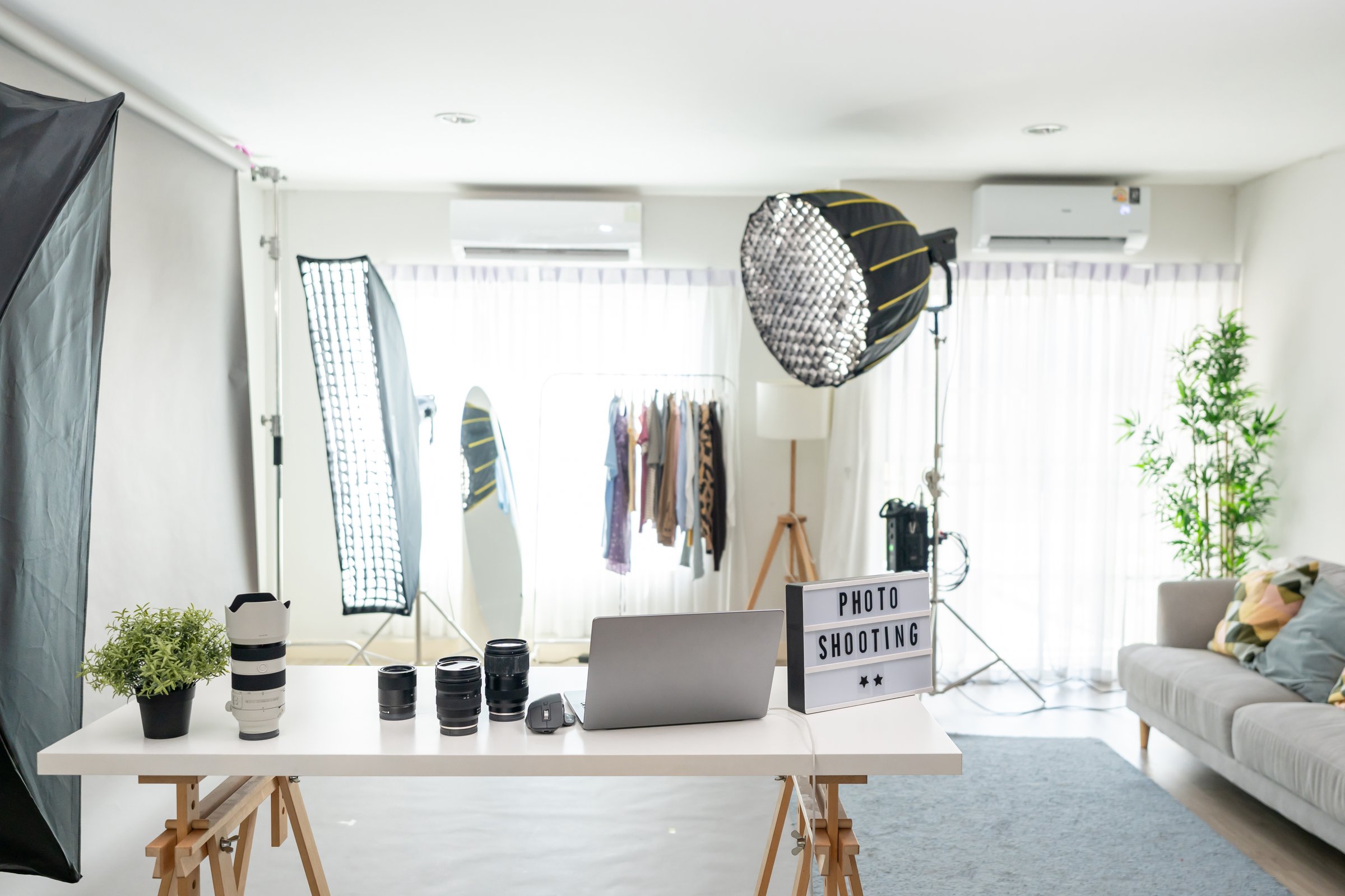 Behind the scenes shot of a photo shoot with lighting setup without people. A behind the scenes view of a photo shoot setup featuring professional lighting equipment using filming techniques in studio