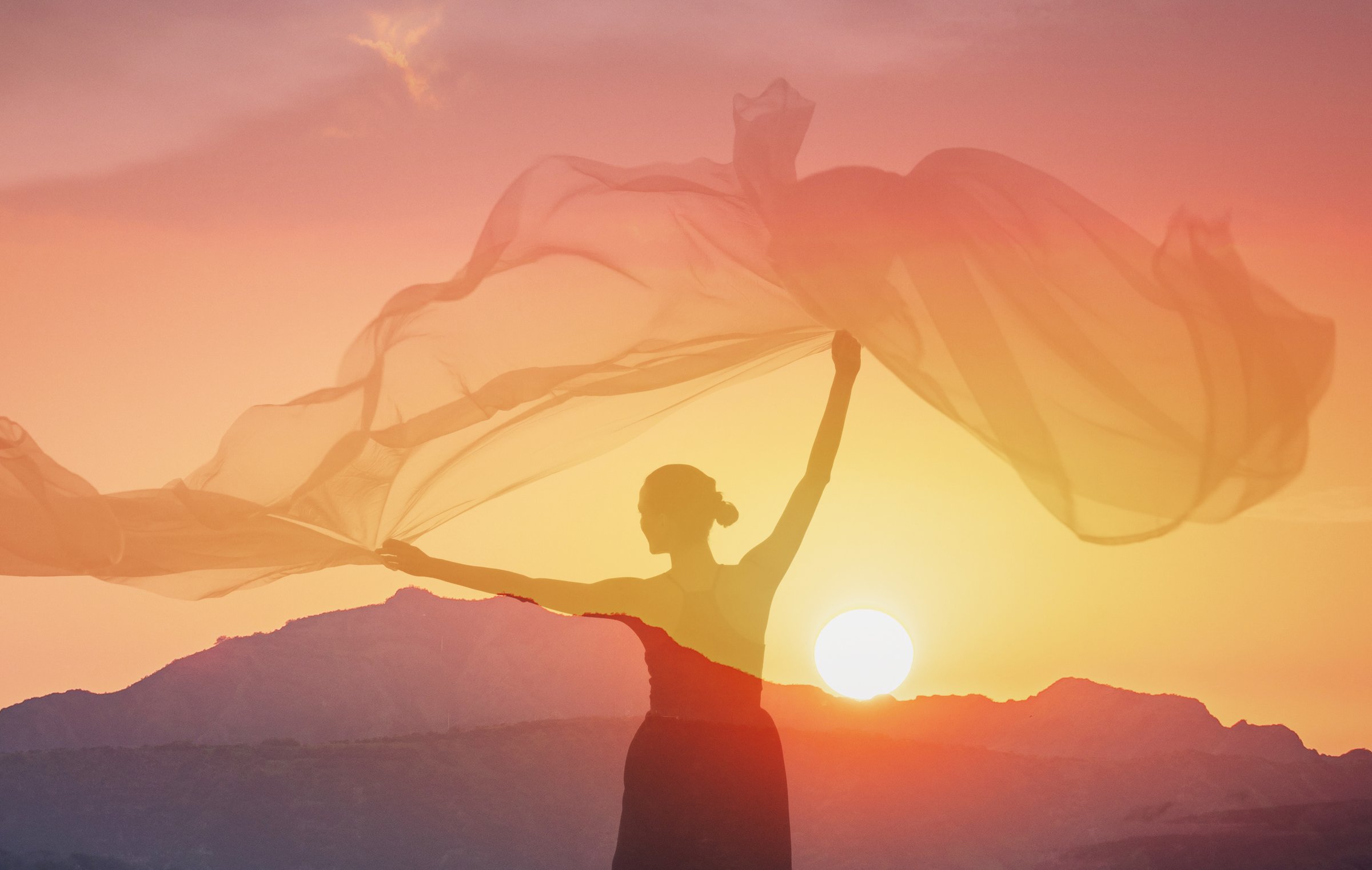 Carefree woman at sunset.