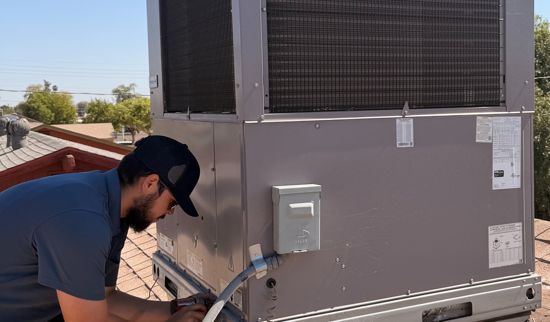HVAC technician working on AC unit