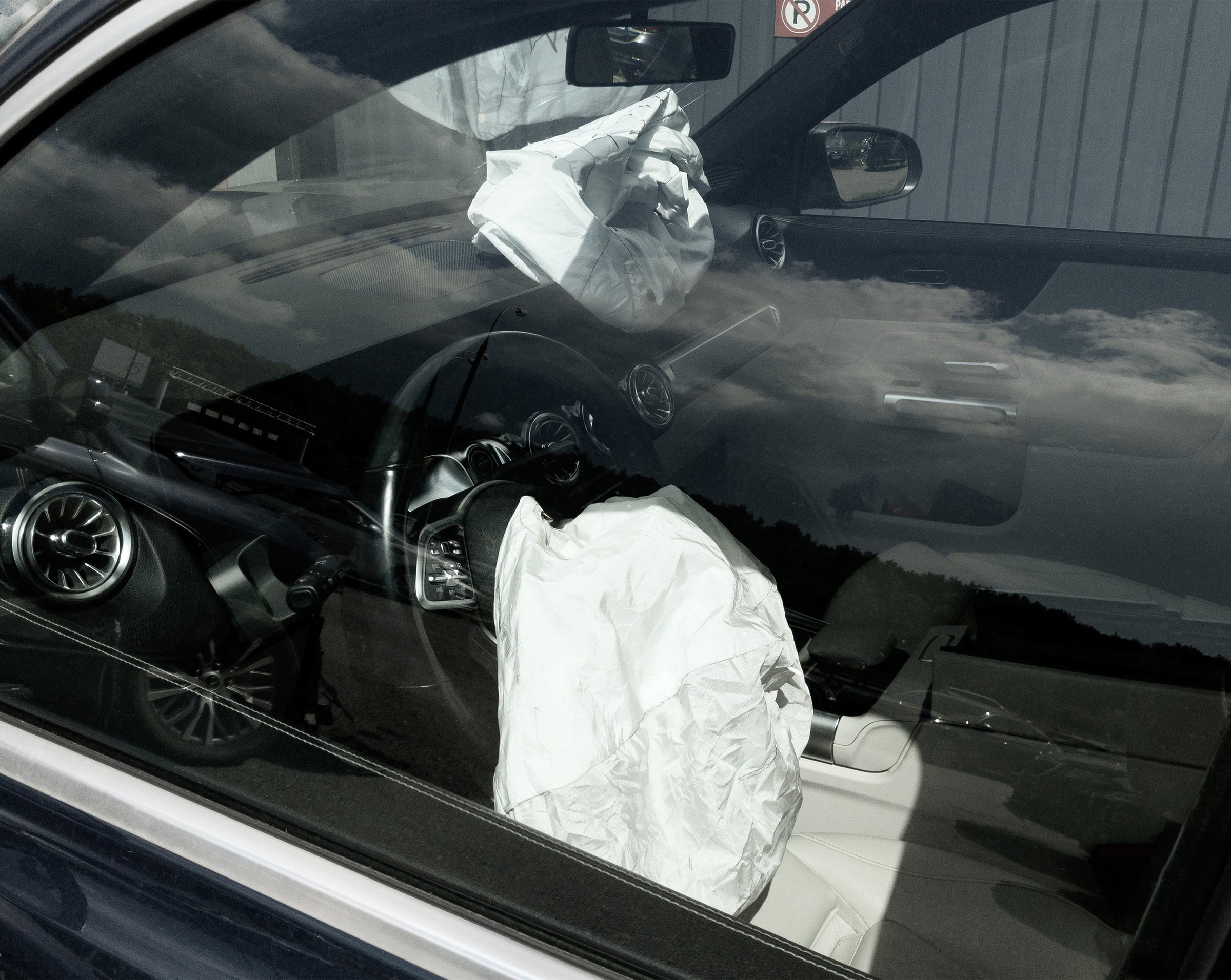 luxury car with its opened airbags due frontal impact